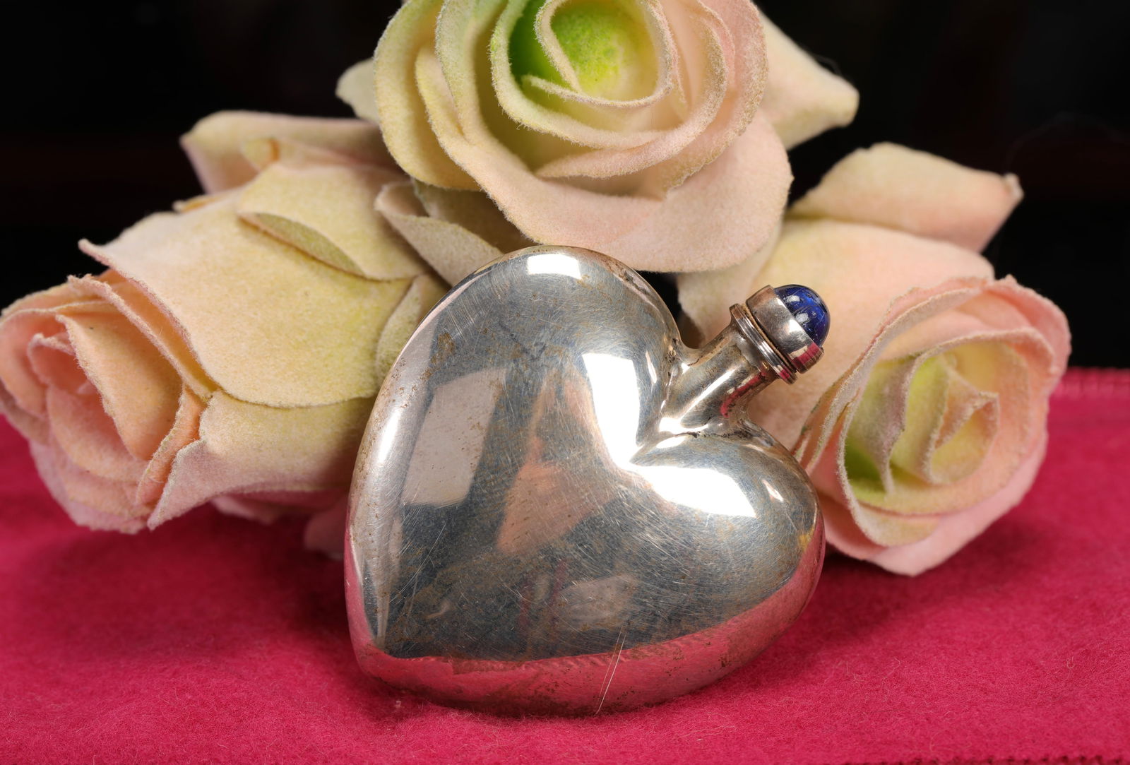 MEXICAN STERLING SILVER HEART SHAPED PERFUME BOTTLE: A Mexican sterling silver heart shaped perfume bottle with silver & blue glass perfume dobber/ stopper. Marked on inside of lid. As pictured. No damage noted. Measurements:2" x 1.75". total weight: 16