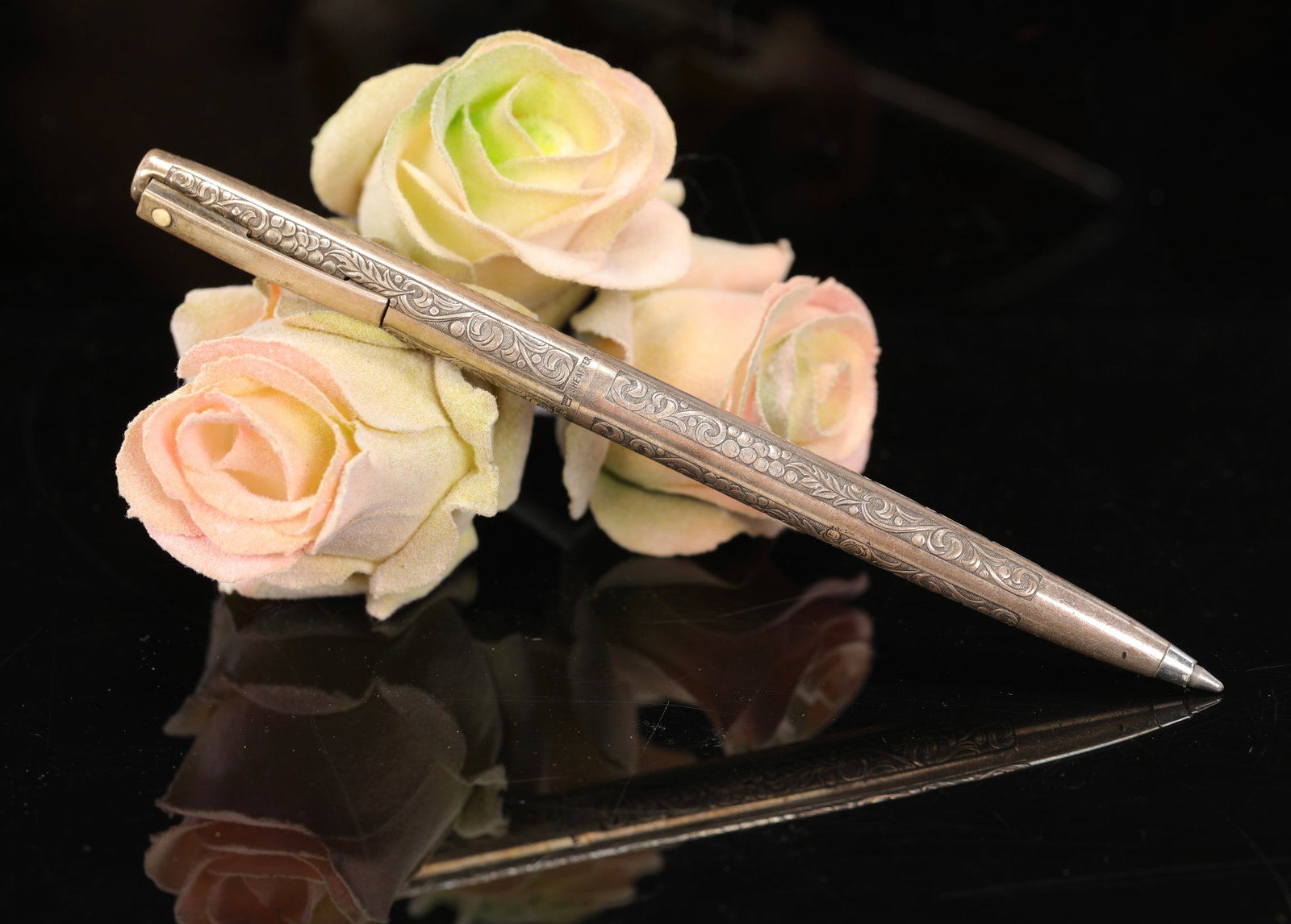 SHEAFFER ORNATE STERLING SILVER PEN: An ornately engraved sterling silver ballpoint pen made by Sheaffer. Marked around center of pen. As pictured. No damage noted. Measures: 5.25" L. Total weight: 21 grams.