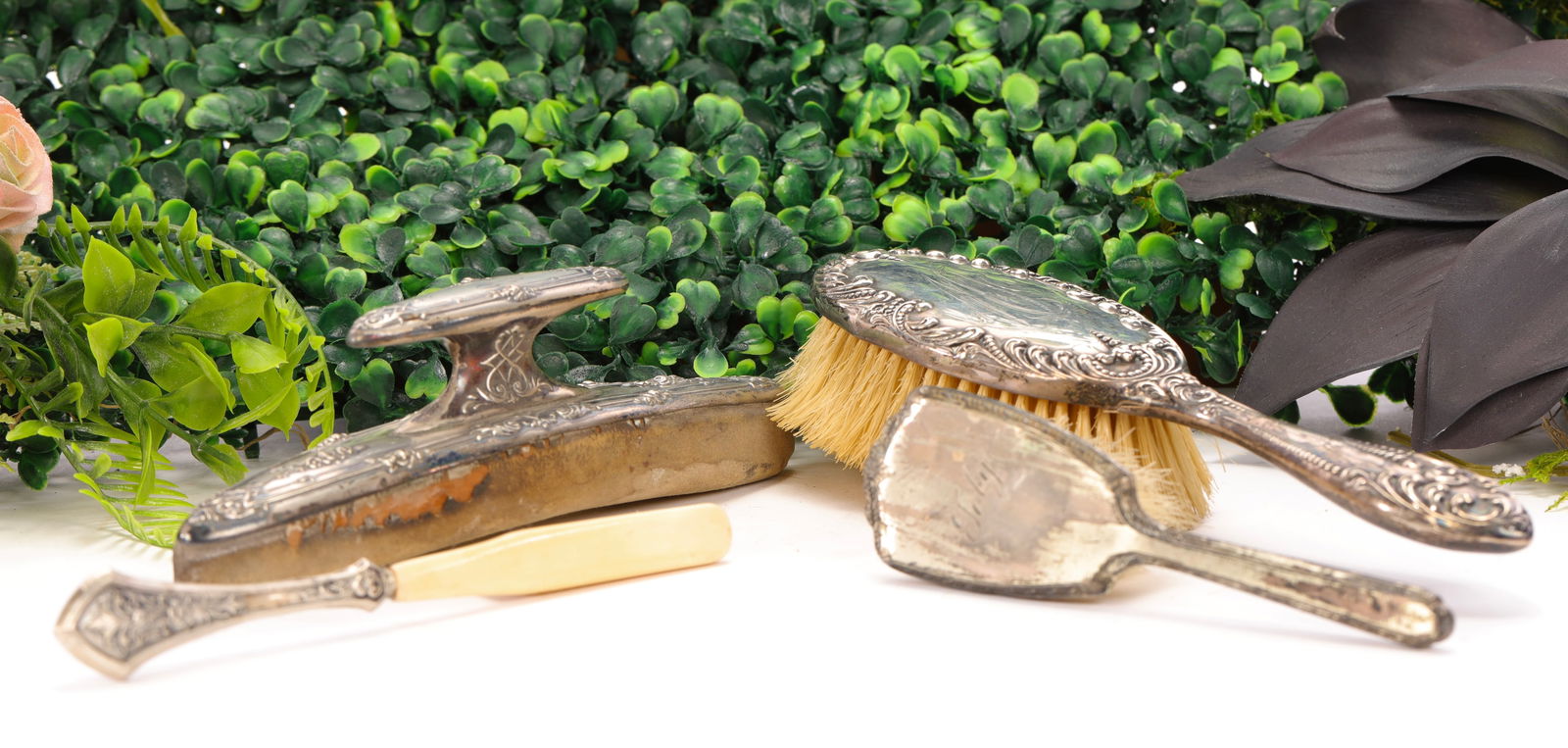 ART NOUVEAU ANTIQUE STERLING SILVER VANITY BRUSHES: A lot of four antique Victorian and Art Nouveau sterling silver vanity items:1. Small sterling child's brush with "Toby" monogrammed on back. As pictured. 5.25" L2. Foster & Bailey full-sized sterling