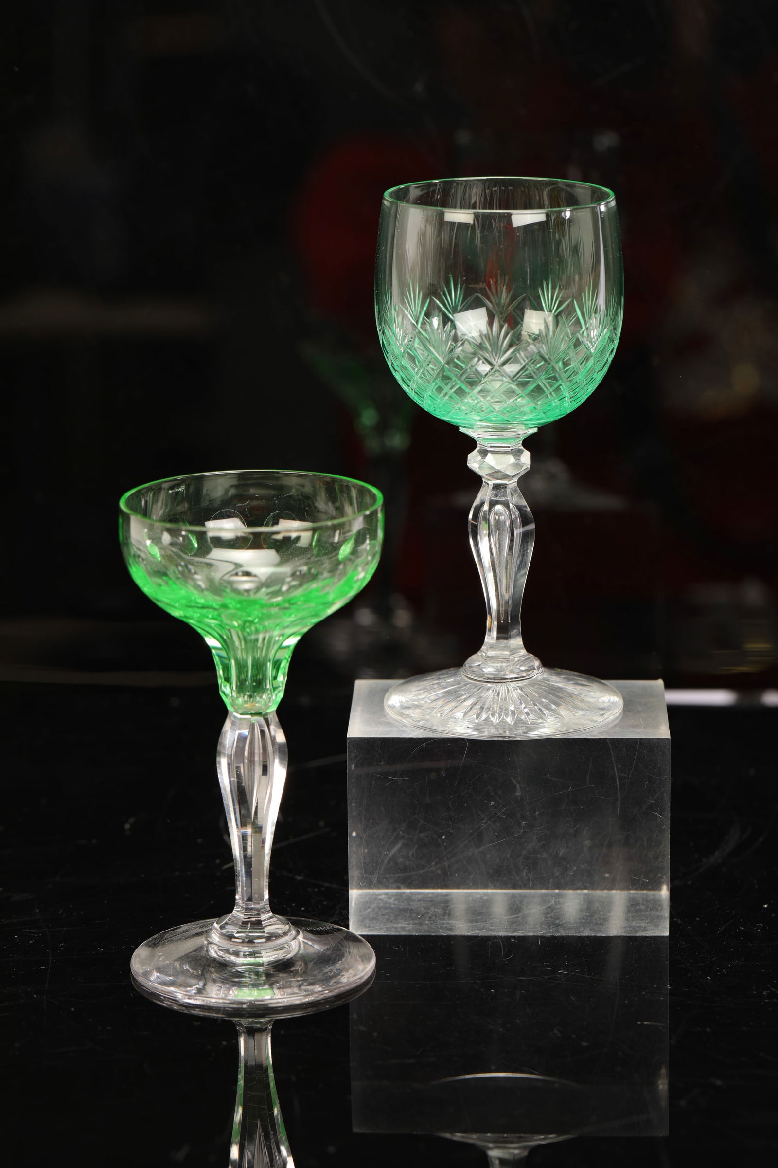 2 URANIUM CUT GLASS STEMMED GOBLETS: A pair of cut glass stemmed goblets. Both are uranium glass and glow under a black light. 1. pineapple/ fan pattern: 5.25" H x 2.25" dia2. coin pattern: 4.75" H x 2.5" dia