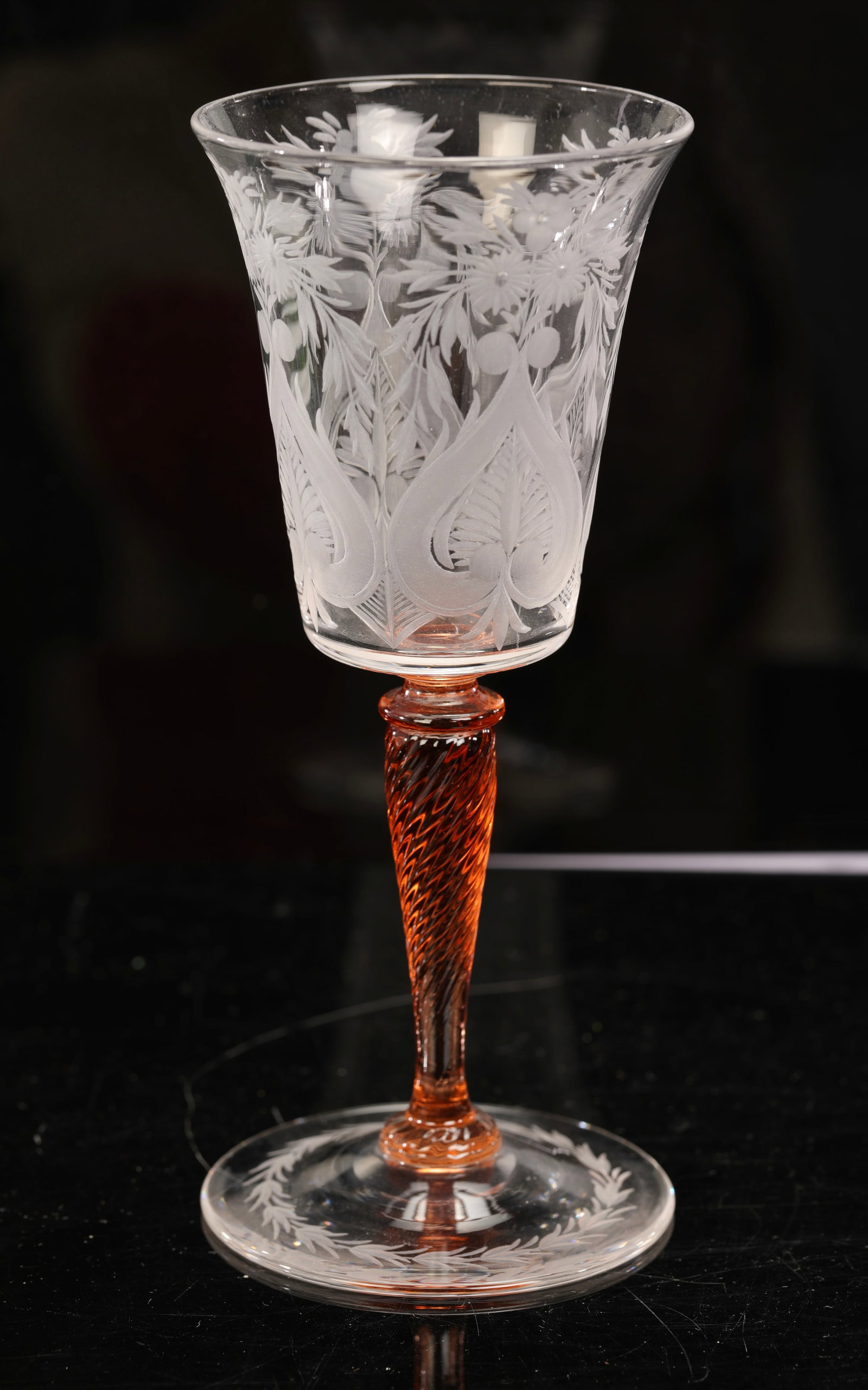 STEUBEN VAN DYKE ETCHED COCKTAIL GLASS WINE STEM: A gorgeous Steuben Van Dyke blown glass with peach twist stem and finely etched glass and base. 7" H x 3" diameter.