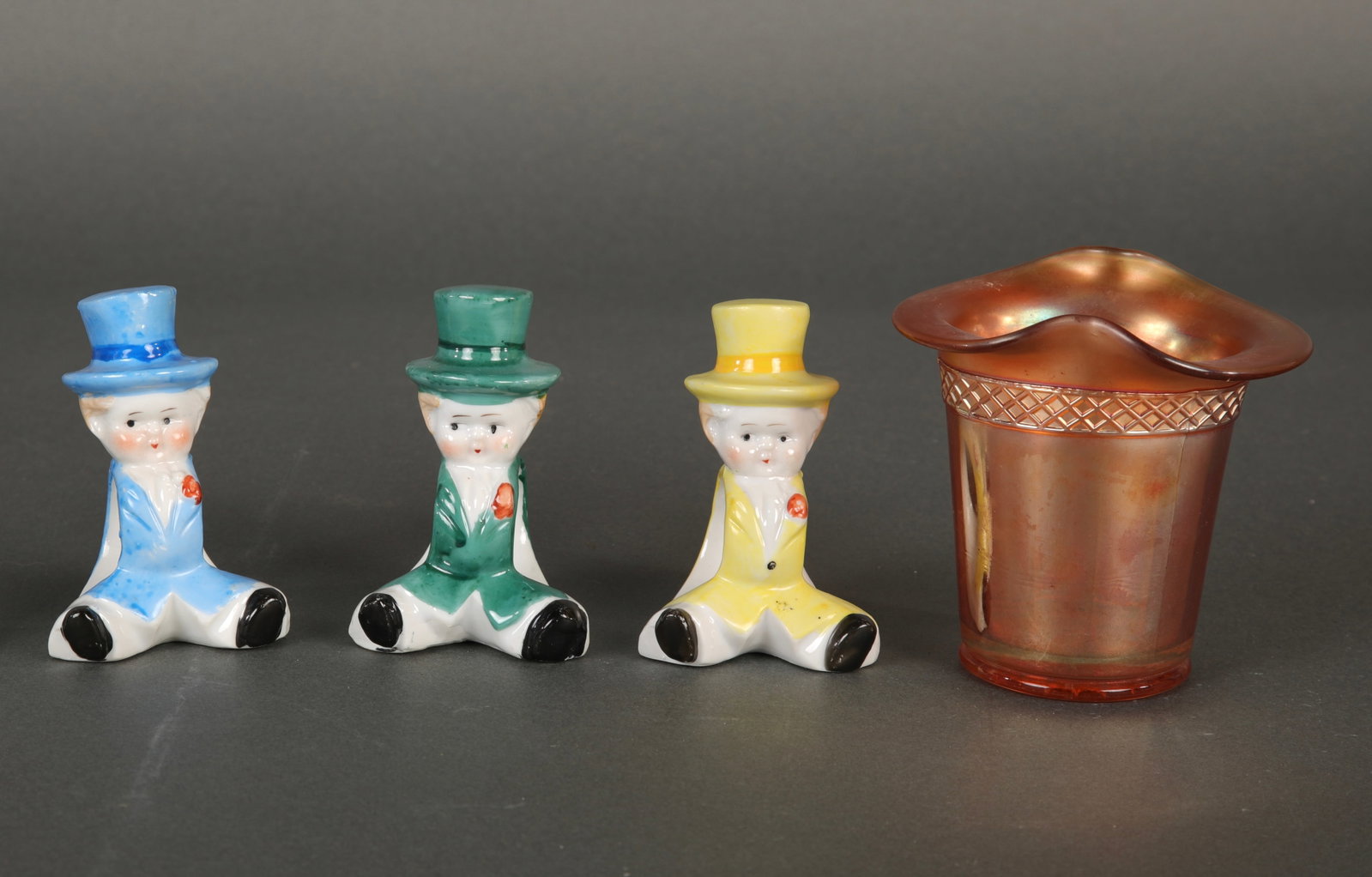 VTG PORCELAIN DOLL NAPKIN RINGS & CARNIVAL GLASS CUP: A group of three adorable little porcelain boy napkin rings. Marked made in Japan on bottom. Also includes a marigold carnival glass cup.