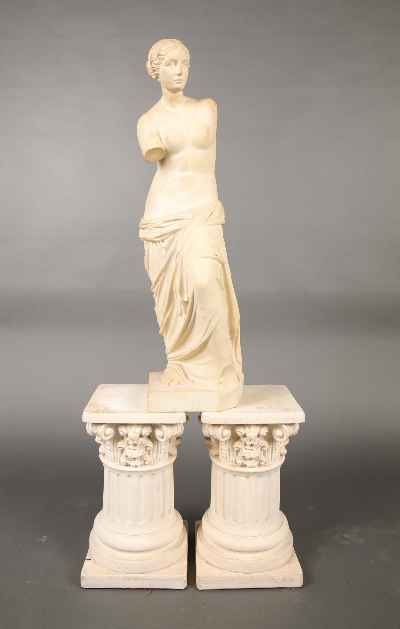 CARVED MARBLE STATUE & 2 PLASTER NEO-CLASSICAL PILLAR BASES: A lovely carved marble statue of a partially nude woman with a pair of plaster Neo-Classical pillar bases. The statue is very heavy, as it is marble. Measures: 34" H x 9" W