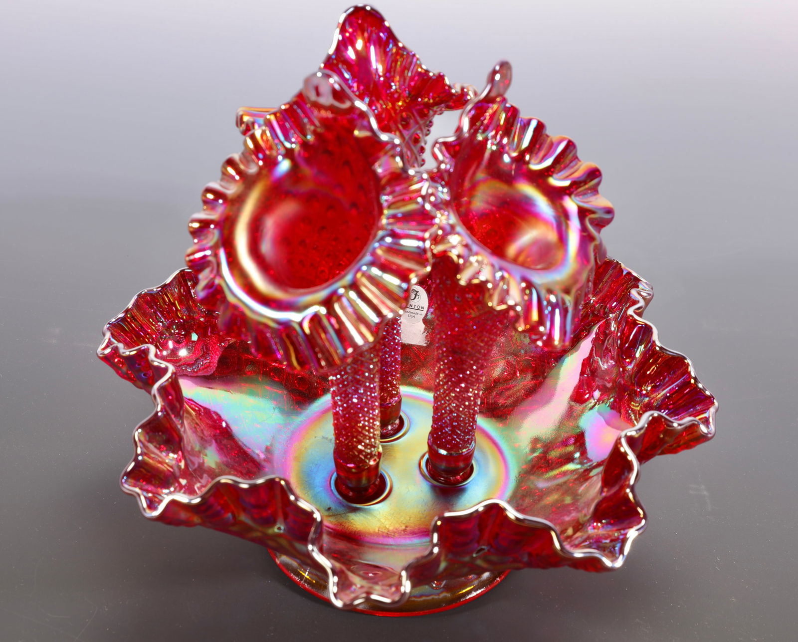 FENTON RED IRIDESCENT CARNIVAL GLASS 3 HORN EPERGNE: A gorgeous Fenton red iridescent carnival glass 3 horn epergne with ruffled edges. Original Fenton label in tact. Measures: 10" x 10" INV-#-