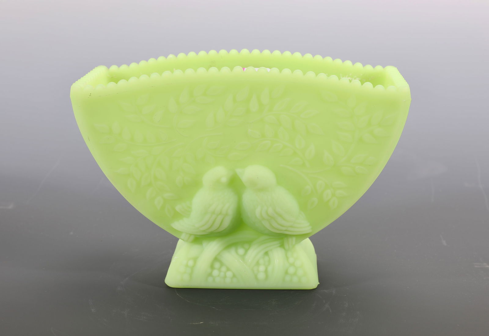 FENTON URANIUM GREEN CUSTARD GLASS LOVE BIRDS DISH: A vintage Fenton uranium green custard glass dish or planter with raised love birds design. Marked Fenton on base. Measures: 4.5" H x 6.5" W INV # -