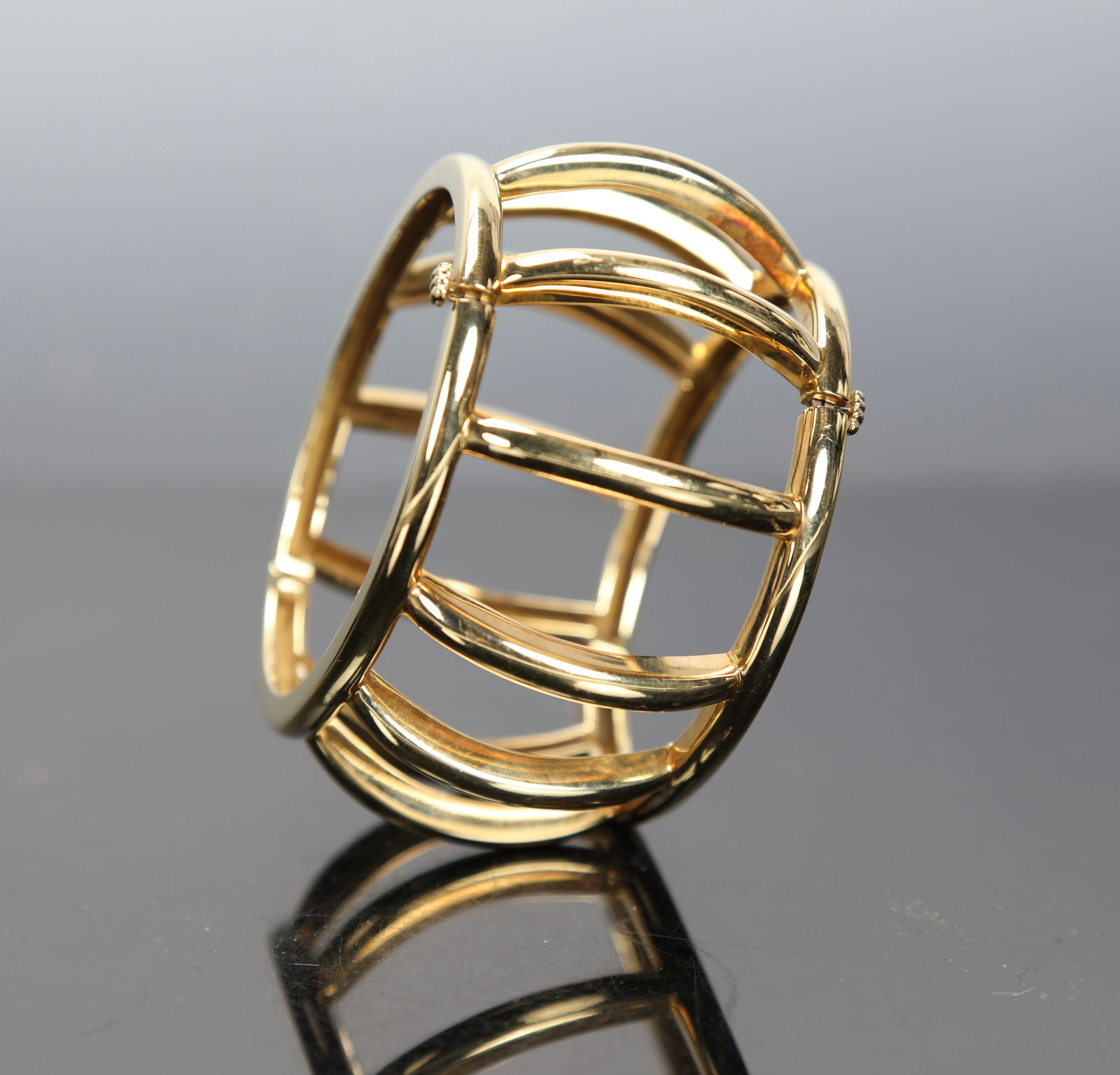 18K GOLD TIFFANY & CO. PALOMA PICASSO CAGE CUFF BANGLE BRACELET: A phenomenal 18K gold cage cuff hinged bangle bracelet. Designed by Paloma Picasso and produced by Tiffany & Co. Marked on inside. Total Weight: 98 grams measures:3"W x 1.5"H Interior measurements: 2.