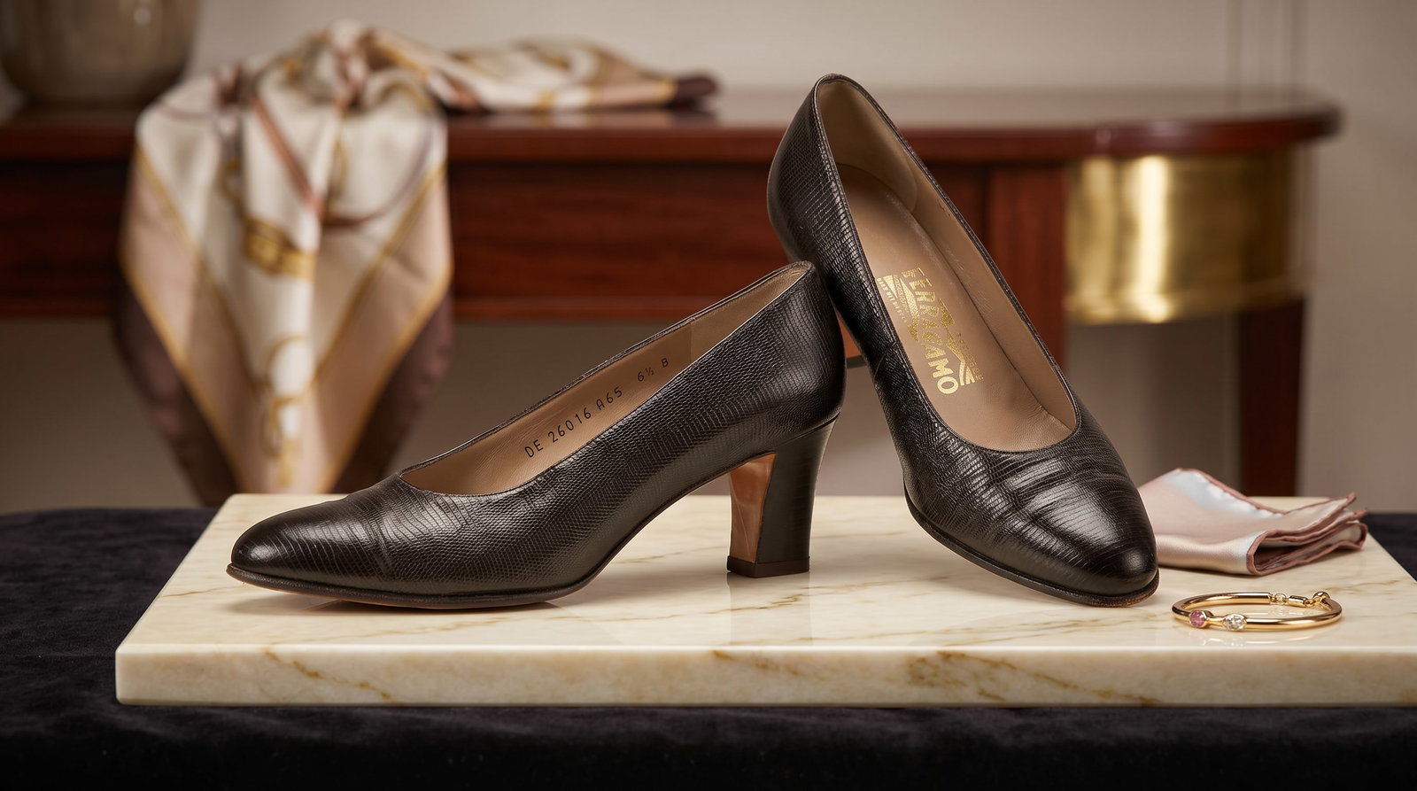SALVATORE FERRAGAMO LIZARD-EMBOSSED LEATHER PUMPS: These vintage Salvatore Ferragamo pumps showcase the brand's signature Italian craftsmanship with a sophisticated structured design. Upper: Made from premium lizard-embossed calfskin leather,