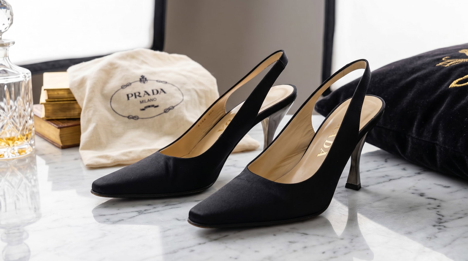 PRADA SATIN BLACK SLINGBACK PUMPS: These vintage Prada slingback pumps showcase the minimalist, clean-lined elegance characteristic of the fashion house's late 1990s and early 2000s collections. Upper: Crafted from fine black silk