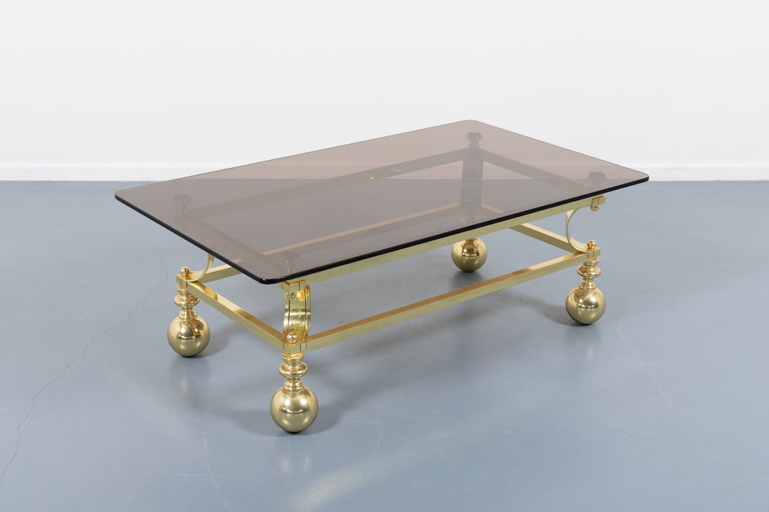 Spectacular coffee table from Marzio Cecchi, Italy 1970’s: sculptural gold colour steel frame and loose smoked glass top designed by Marzio Cecchi.