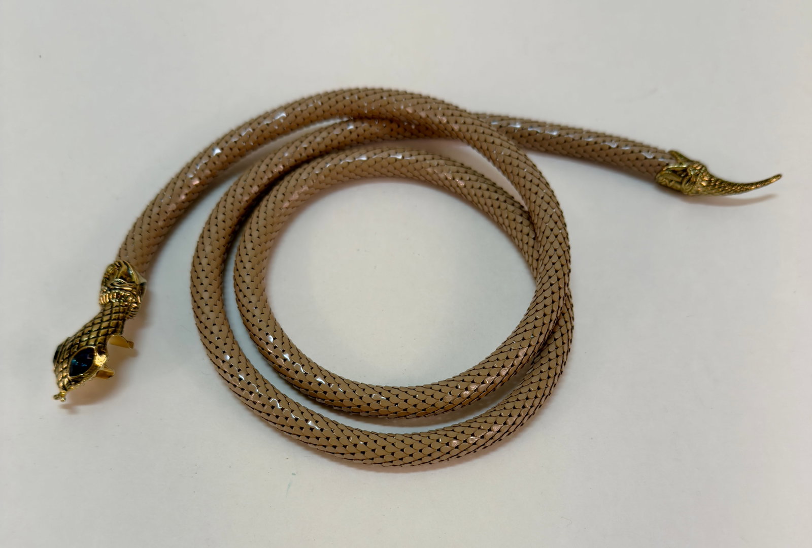 Vintage 1980s DL Auld Snake Head Taupe & Gold Tone Mesh Belt: From an upstate, NY estate collection. Classic 1980s vintage DL Auld taupe mesh snake belt. Gold tone head and tail, with blue rhinestone eyes. Semi-adjustable length. Length measures 42" long from he
