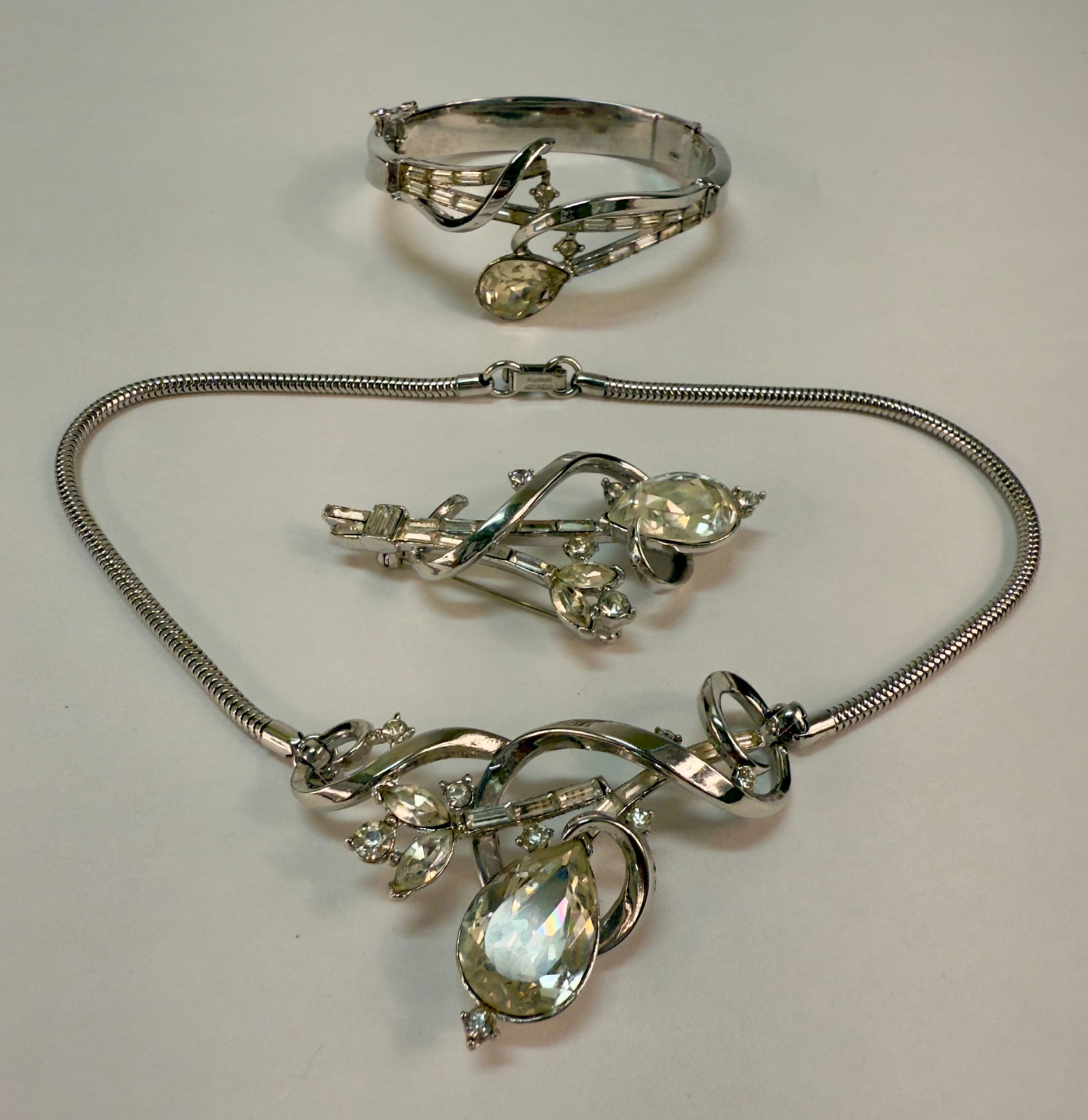 1951 Alfred Philippe Three Piece Jem of India Trifari Brooch Necklace Bracelet Parure: From an upstate, NY estate collection. Three-piece parure / set designed by Alfred Philippe for Trifari in 1951, Jem of India. Silver tone necklace, hinged bracelet with safety catch, and pin / brooch