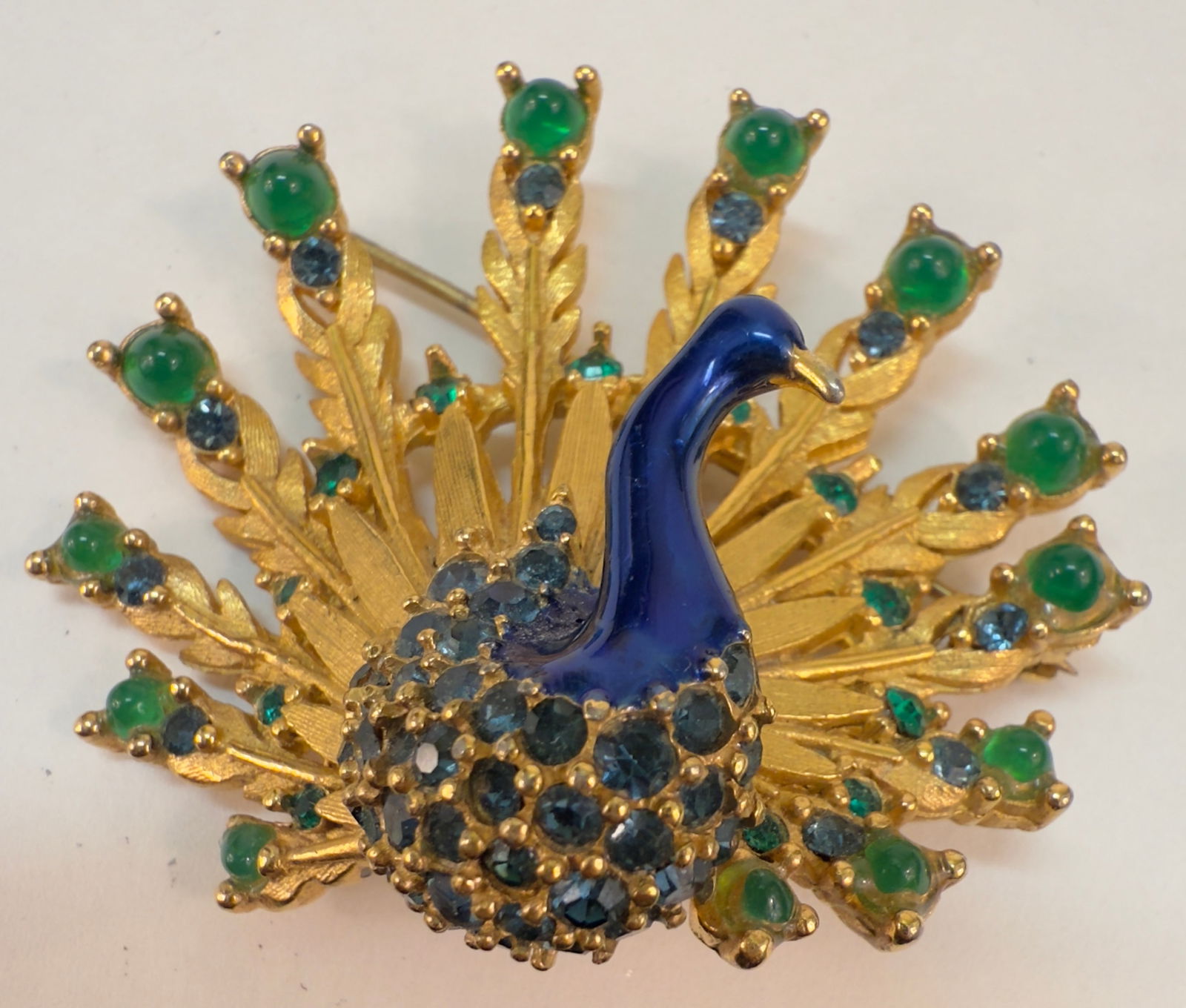 Vintage Marcel Boucher Blue & Green Peacock Pin Brooch: From an upstate, NY estate collection. Unsigned Marcel Boucher pin or brooch, in the shape of a peacock. With green round glass stones, green and blue rhinestones, and enamel detail. Gold tone, barrel