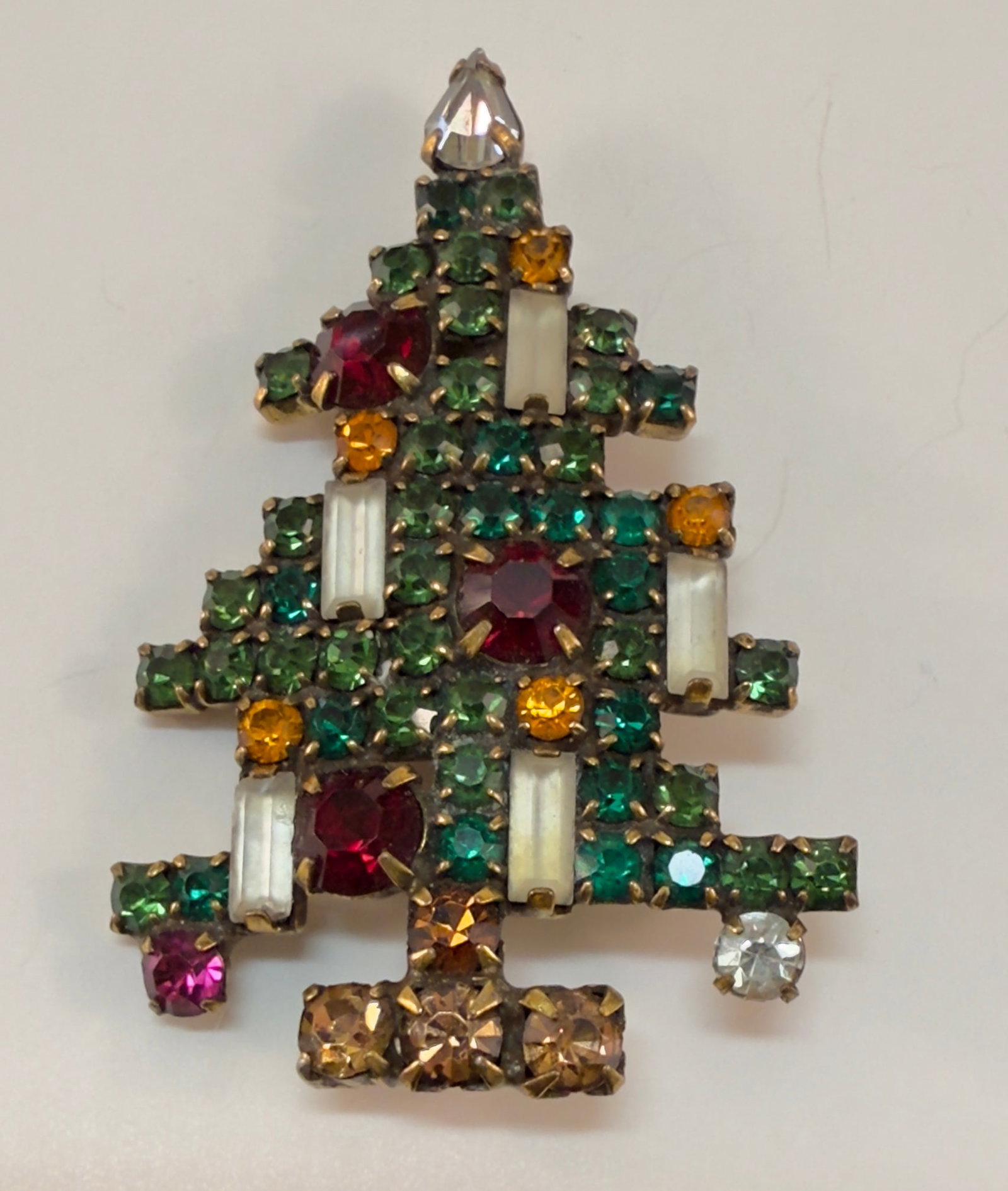 Vintage Mid Century Modernist Weiss Christmas Tree Brooch Pin: From an upstate, NY estate collection. Vintage modernist Christmas Tree brooch with multi-colored rhinestones. Signed. Gold tone. Barrel clasp. Measures approx 2.125" at longest dimension.