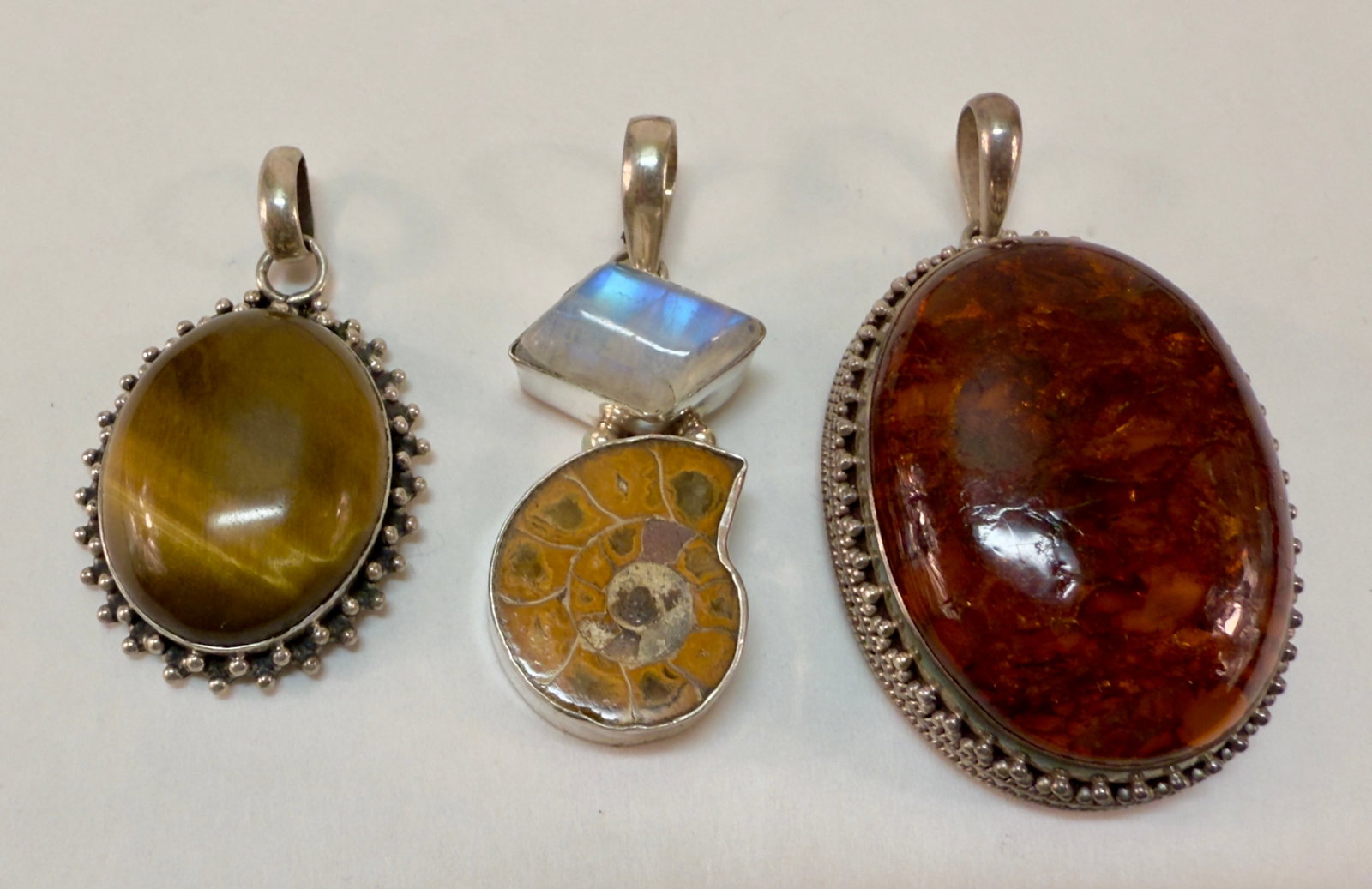 Group of Three Sterling Silver & Semi-Precious Stone Pendants: From an upstate, NY estate collection. Group of three sterling silver and semi-precious stone pendants. All are marked and tested sterling. Group weighs a total of 48.4 grams.