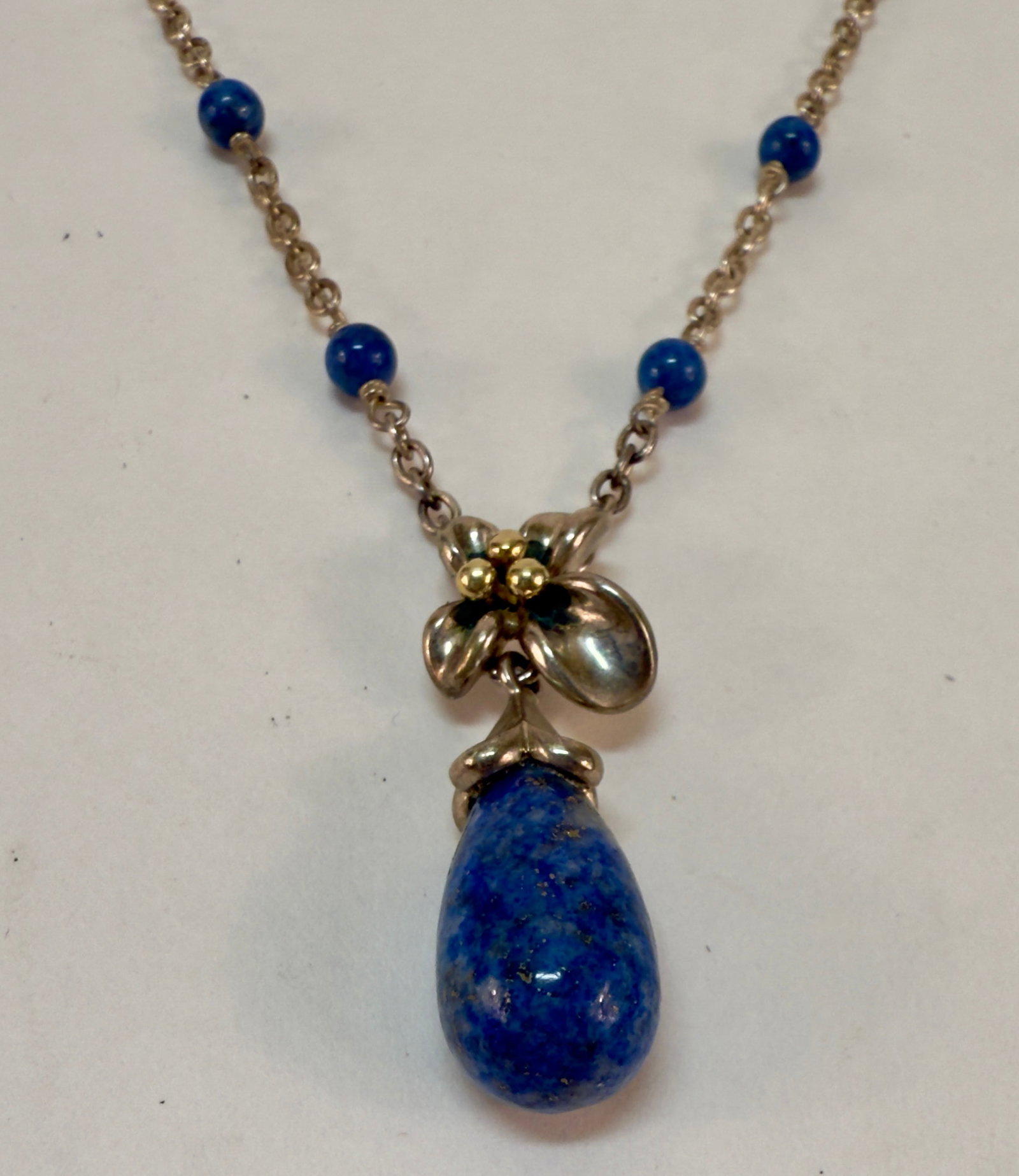 Sterling Silver 18K Gold Flower Necklace with Semi-Precious Stones by Amy King: From an upstate, NY estate collection. Delicate modern sterling silver with 18K gold accents flower necklace with blue semi-precious stones. Marked sterling and with maker's mark for designer Amy King