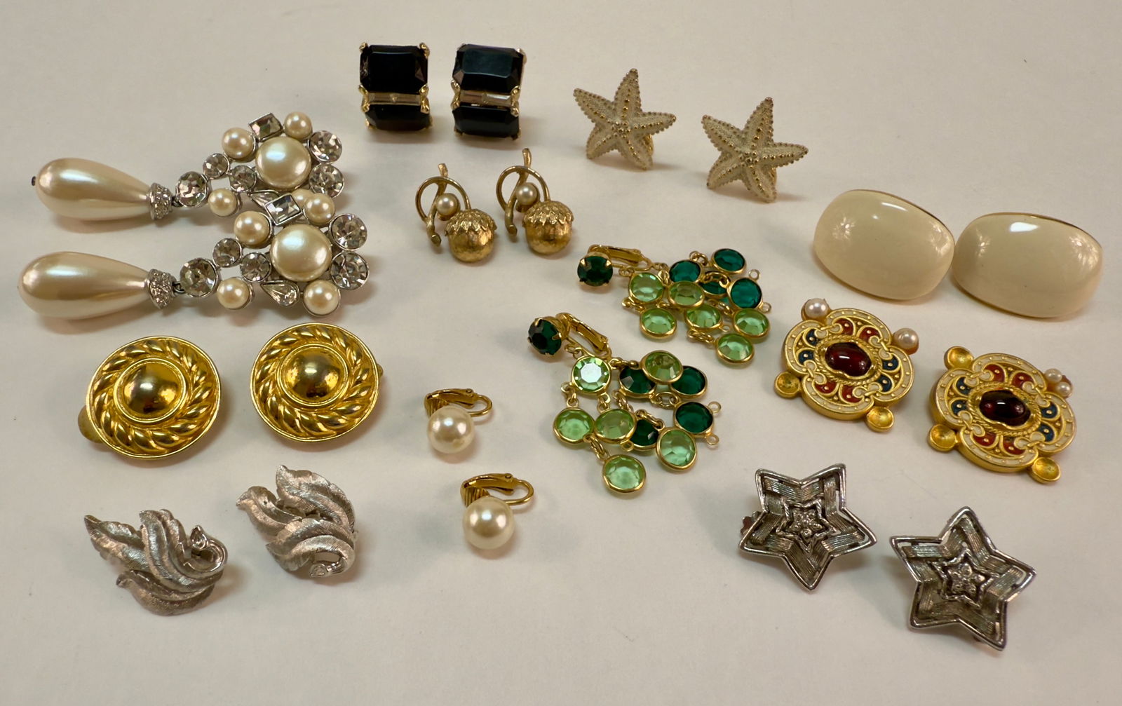 Group of 11 Pair of Vintage Clip Earrings Designer: From an upstate, NY estate collection. Eleven pairs of vintage clip-on and screw back earrings, some signed such as Anne Klein, Sarah Coventry, Monet, Napier, +.