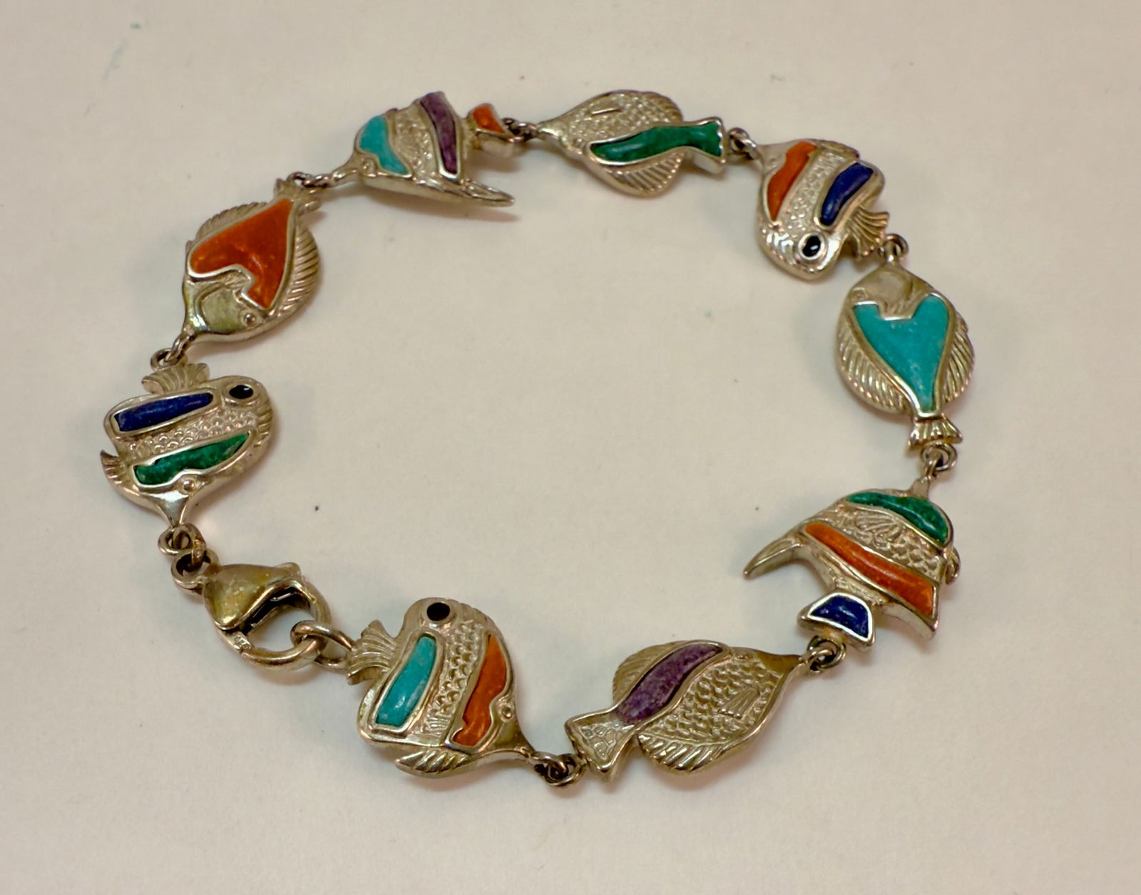 Sterling Silver Enameled Colorful Fish Design Bracelet: From an upstate, NY estate collection. Sterling silver colorful design bracelet with enamel. Marked 925 and with a maker's mark. Claw clasp. Measures approx 7.5" long and approx 14mm at widest. Weighs