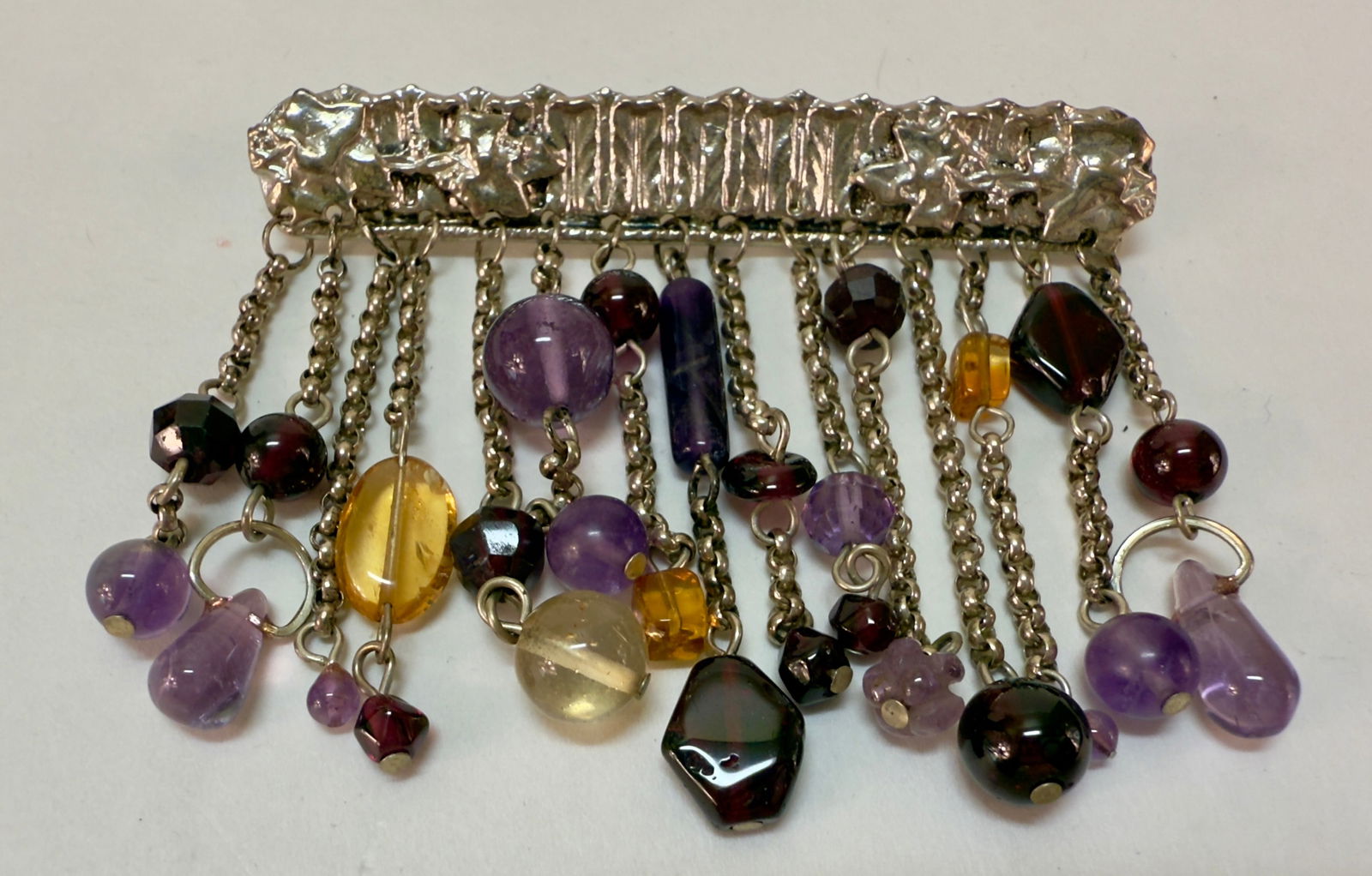 Sterling Silver Bar Pin Brooch with Amethyst and Topaz beaded Dangles: From an upstate, NY estate collection. Sterling silver bar pin or brooch with graphic and foliate design, and beaded amethyst & topaz beaded dangles. Marked sterling and signed illegibly on back of pi