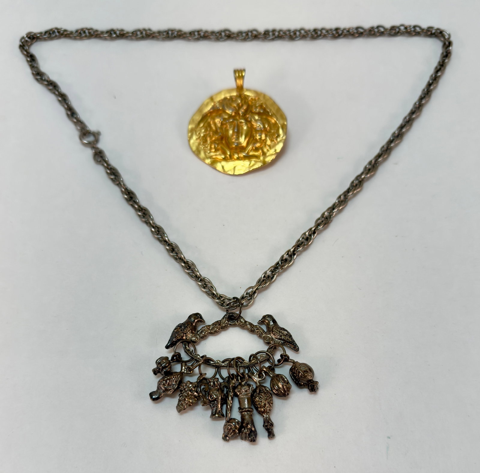 Vintage Sphinx Medusa British Museum Pendant & Balangandan Charm Necklace: From an upstate, NY estate. Vintage British Museum gold tone Sphynx or Medusa pendant and vintage Balangandan style pendant on a silver tone vintage chain.