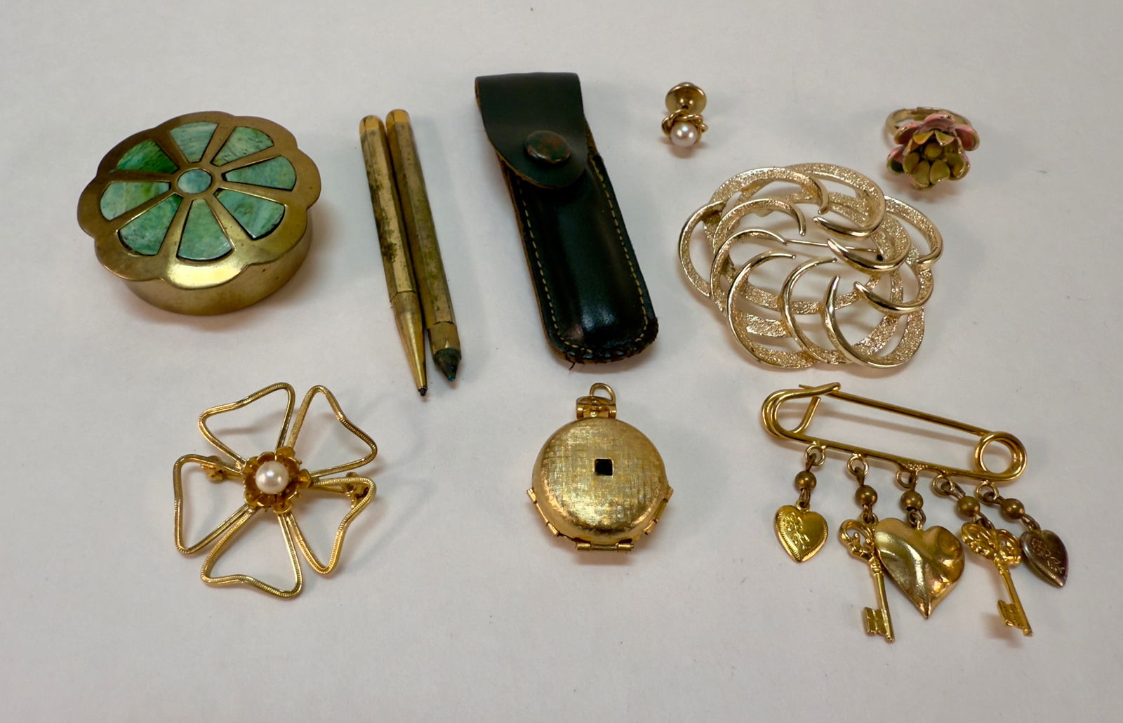 Group of Eight Vintage Jewelry Pieces and Accessories: From an upstate, NY estate. Group of eight vintage jewelry pieces and varied accessories including pen/pencil set in leather pouch, brass box with green enameled lid, pins, enameled rose ring, Four Fr