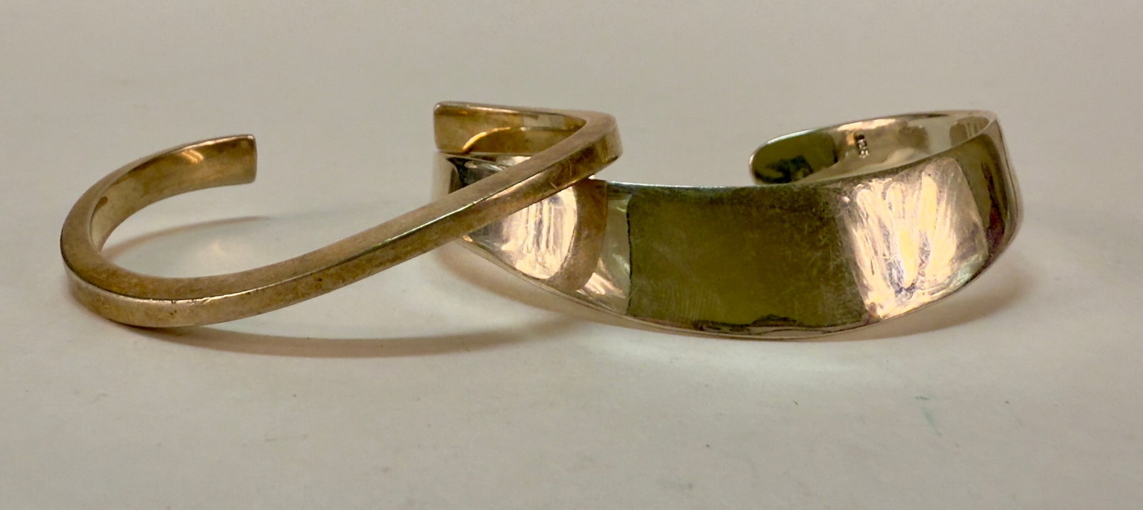 Pair of Vintage Modernist Design Sterling Silver Cuff Bracelets: From an upstate, NY estate. Pair of modernist sterling silver open cuff bracelets, with lovely organic form. Both are marked with 925 or Sterling and thinner one has a sun or star like maker's mark. C