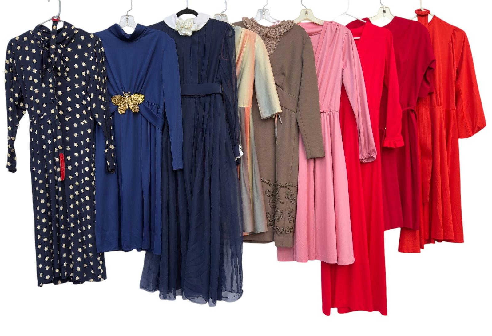 Group of Nine Vintage Women's Dresses Butterfly Embellishment 1940s-1980s: From an upstate, NY estate. Group of nine vintage dresses including: long sleeved blue dress with large gold toned metal butterfly embellishment approx size M, long sheer sleeved white silk flower emb