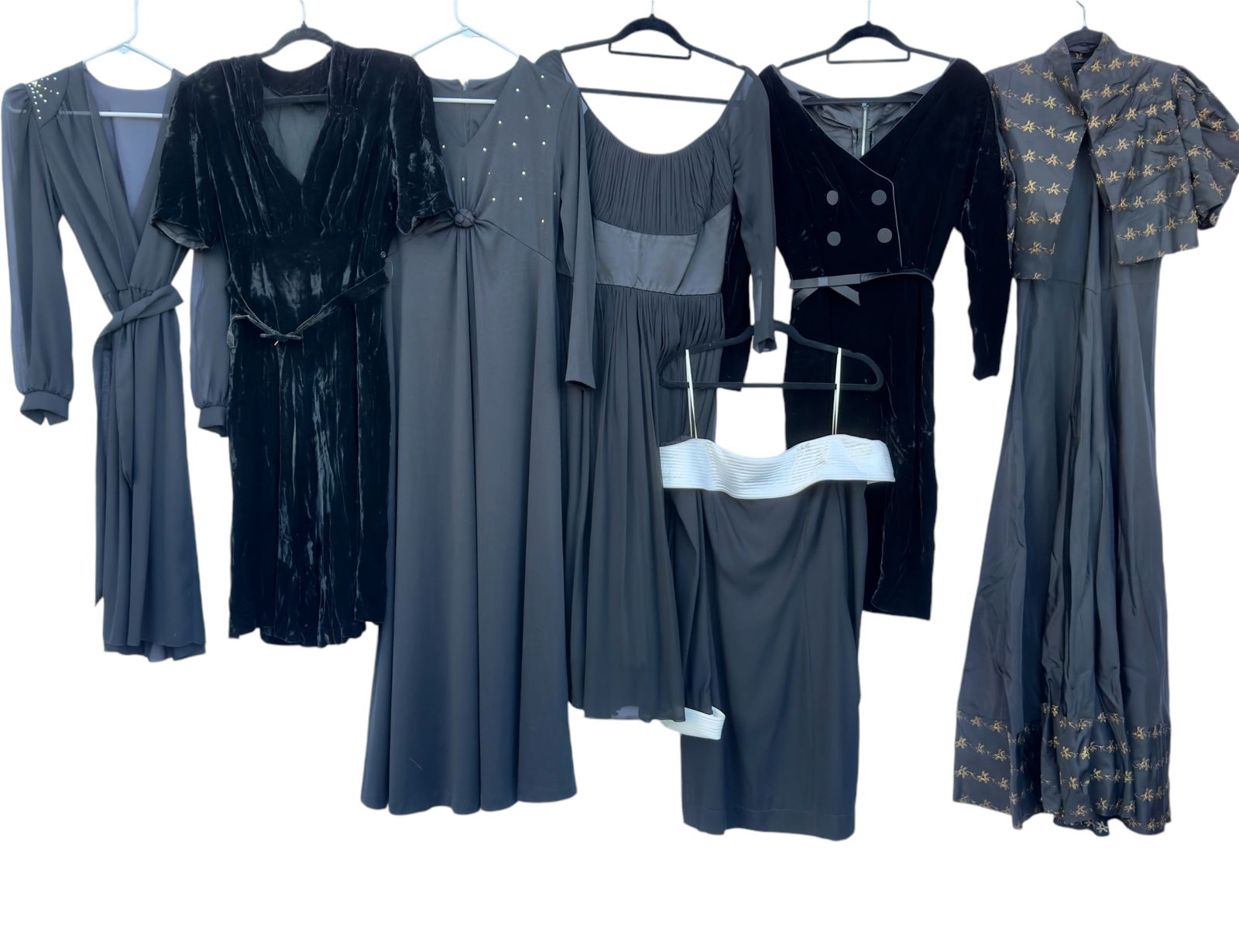 Group of Seven Vintage Women's Dresses Black Silk Velvet 1940s-1990s: From an upstate, NY estate. Group of seven vintage black dresses including: off the shoulder with quilted white satiny material at cuffs and collar tagged AJ Bari size 10, black long sleeved maxi dres