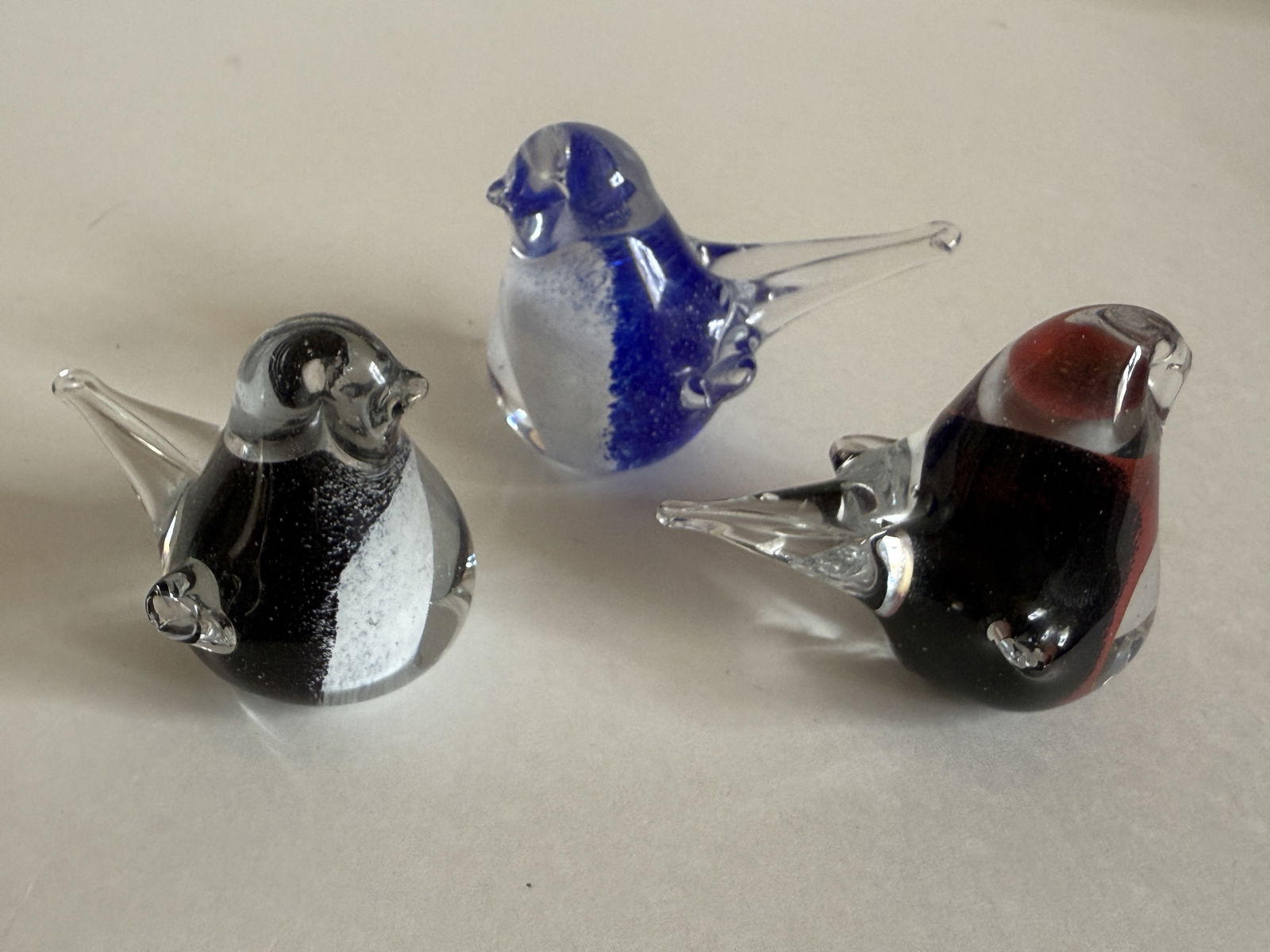 Group of Three Muurla Finland Art Glass Bird Figurines Sculpture Paperweight: From an upstate, NY estate. Group of three hand blown art glass bird figurine / paperweight / sculptures, by Muurla Finland. Sticker on base. Each measures approx 3.5" long x 2.5" tall.