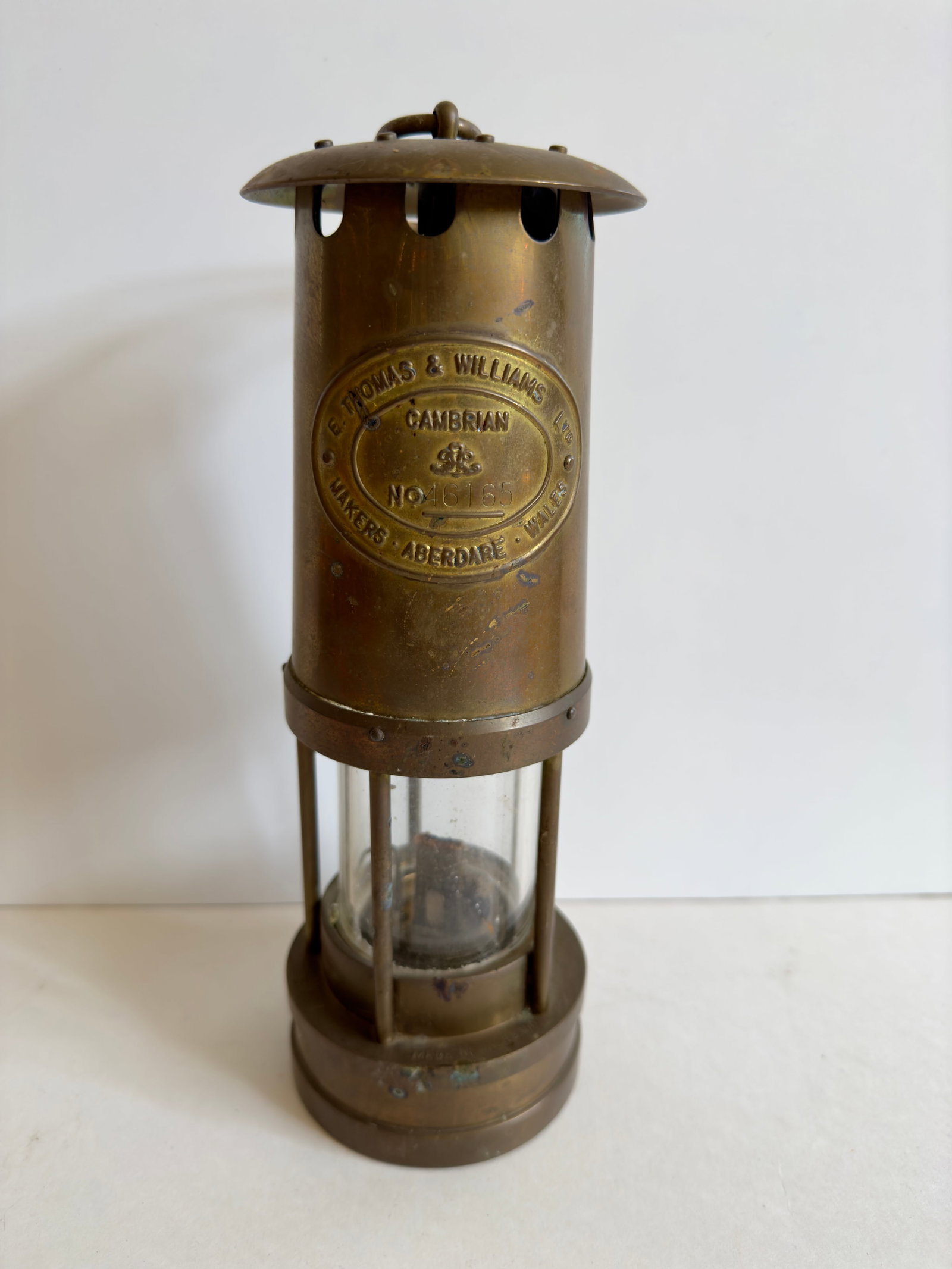Brass Cambrian Miner's Safety Lamp E.Thomas & Williams: From an upstate, NY estate. Vintage brass E. Thomas & Williams Cambrian Miner's Safety Lamp, Aberdare Makers Wales. Numbered 46165. Measures approx 10.25" tall x 3.5" in diameter at base.