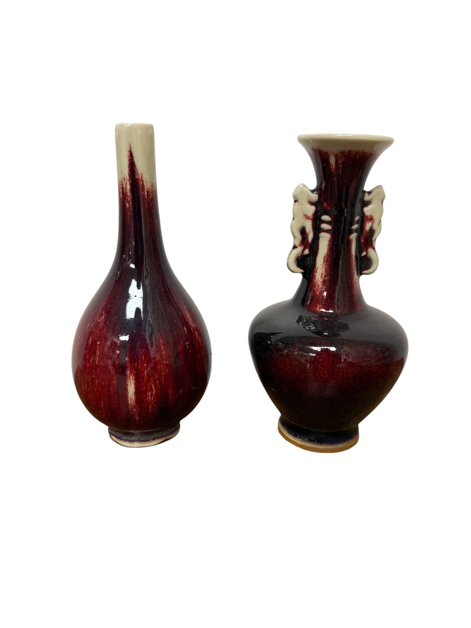 Pair of Small Chinese 20thC Oxblood Glaze Vases: From an upstate, NY estate. Unmatched pair of smaller Chinese 20thC oxblood glaze vases. Each measures approx 7" x 3.5" x 3.5". Please see photos for details.