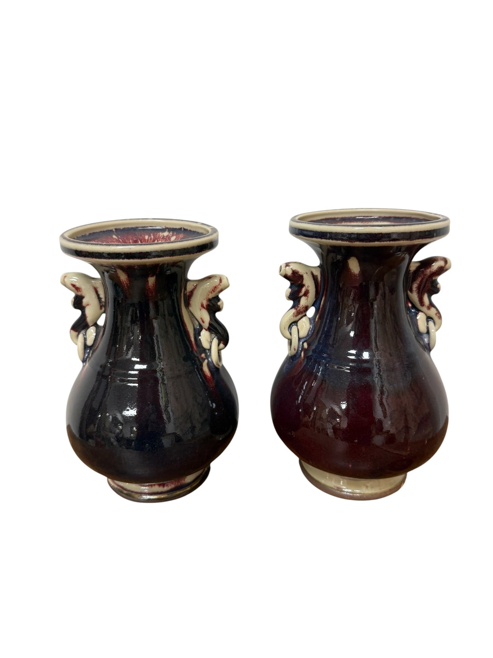 Pair of Chinese 20thC Oxblood Glaze Vases: From an upstate, NY estate. Matched pair of Chinese 20thC oxblood glaze vases, with handles. Each measures approx 8.25" x 5.25" x 5.25". Please see photos for details.