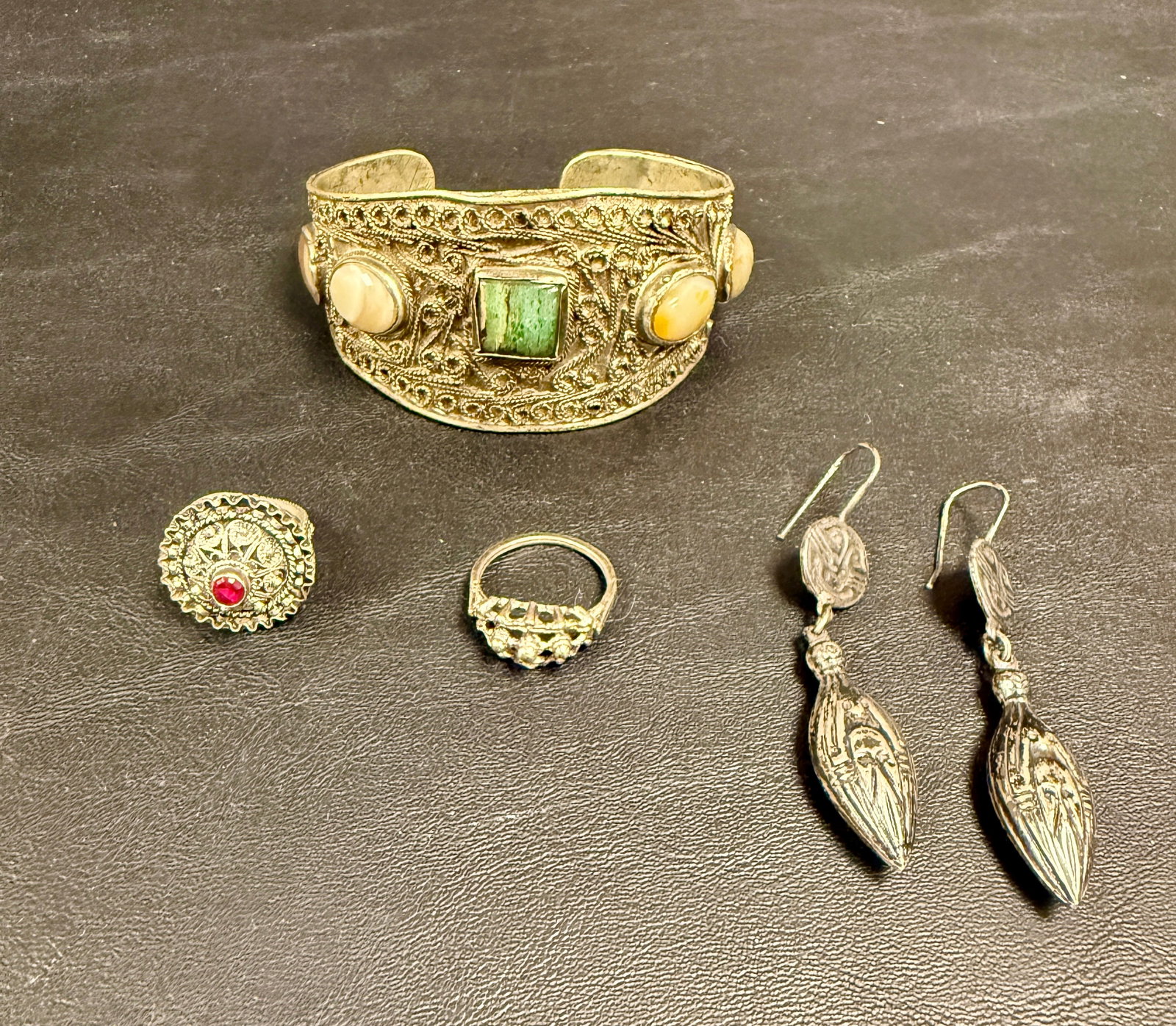 Group Vintage Low Content Silver Jewelry Tibet India: From an upstate, NY estate. Vintage grouping of low content silver jewelry from Tibet and India, including cuff bracelet with semi-precious stones, two rings and one pair of dangle earrings