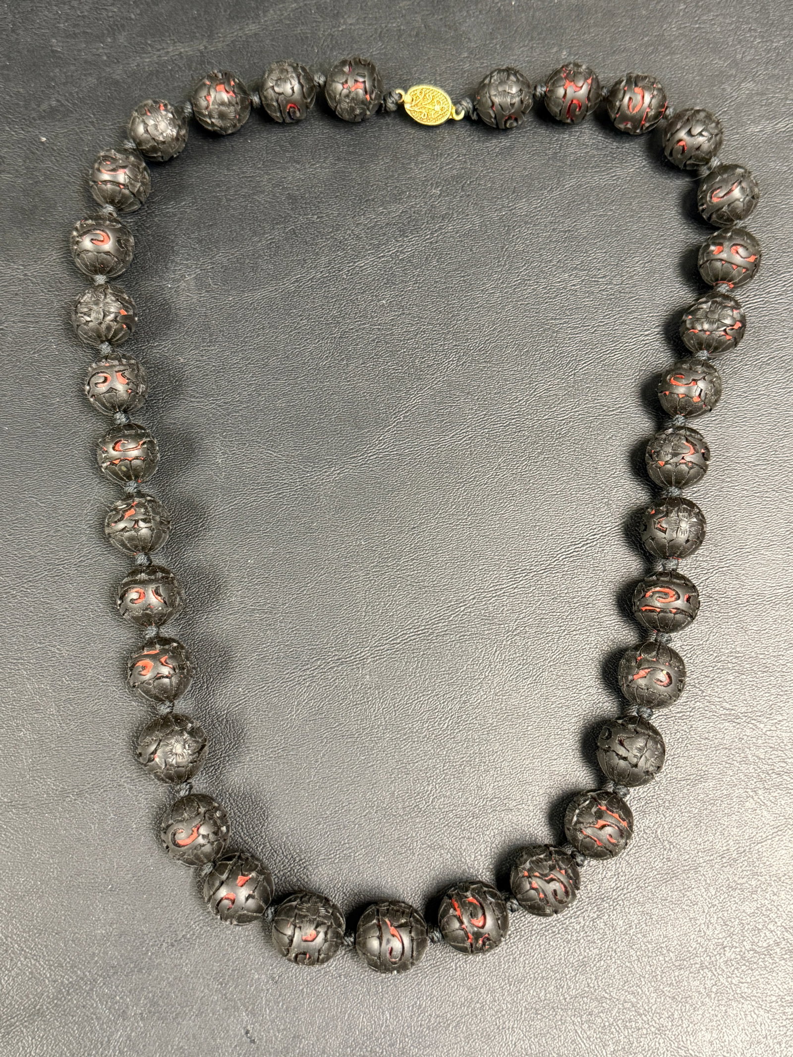 Antique Chinese Carved Black Cinnabar Beaded Necklace: From an upstate, NY estate. Antique Chinese carved black cinnabar beaded necklace. Measures approx 25.75" long. Please see photos for details.