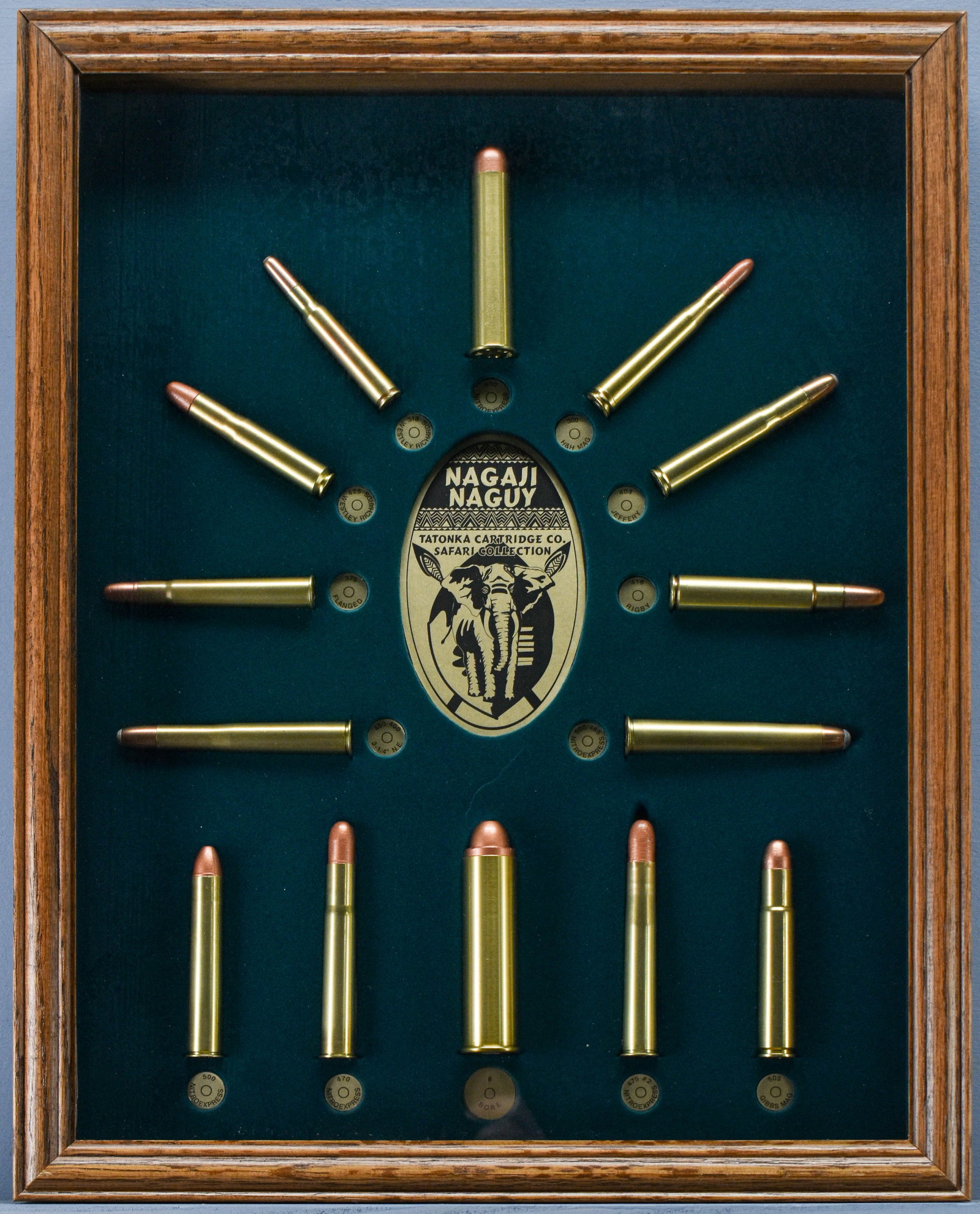 Nagaji Naguy Tatonka Cartridge Co. Safari Collection Shadowbox Display: An extremely fine collection of old, renowned Tatonka safari cartridges displayed in a green velvet-lined walnut case behind glass. Ranging from as small as the 30 Super (a.k.a. 300 H&H) to the giant 