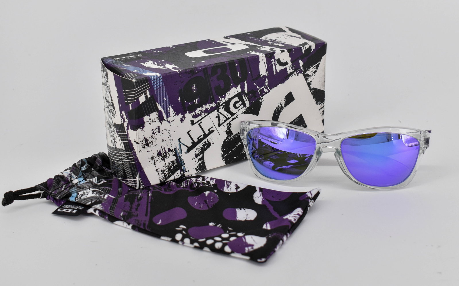 Oakley Sold Out Jupiter Sunglasses, Polished Clear/Violet Iridium: Oakley special edition Sold Out Jupiter sunglasses, with polished clear frame accented with purple and black splatter pattern and violet iridium lenses. Model 24-206 58 16. In original box. Comes with