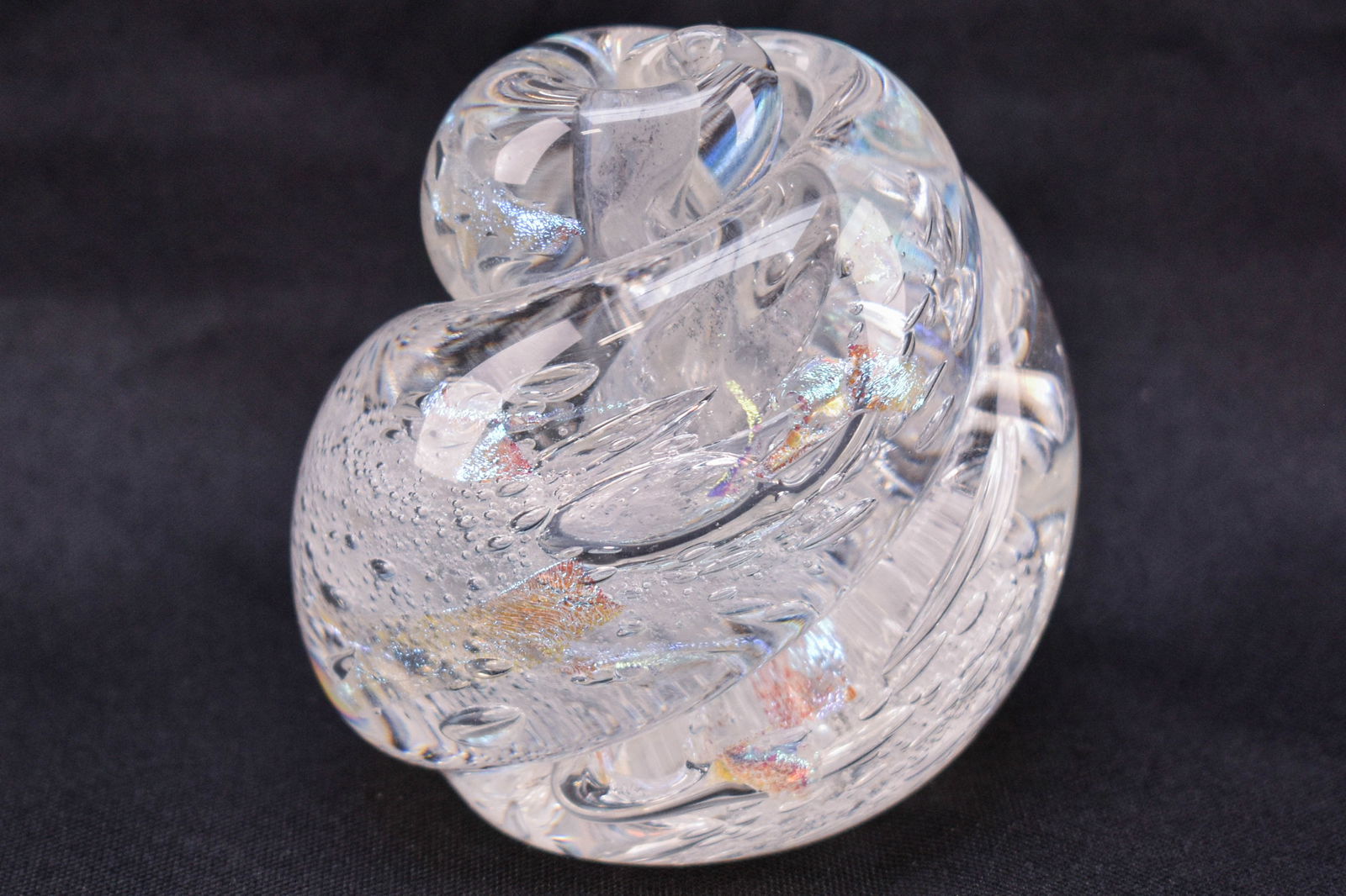 Rollin Karg, Swirled Dichroic Iridescent Art Glass Paperweight: Signed art glass paperweight by Rollin Karg, with a swirled figure and dichroic iridescent fragments and bubbles within.