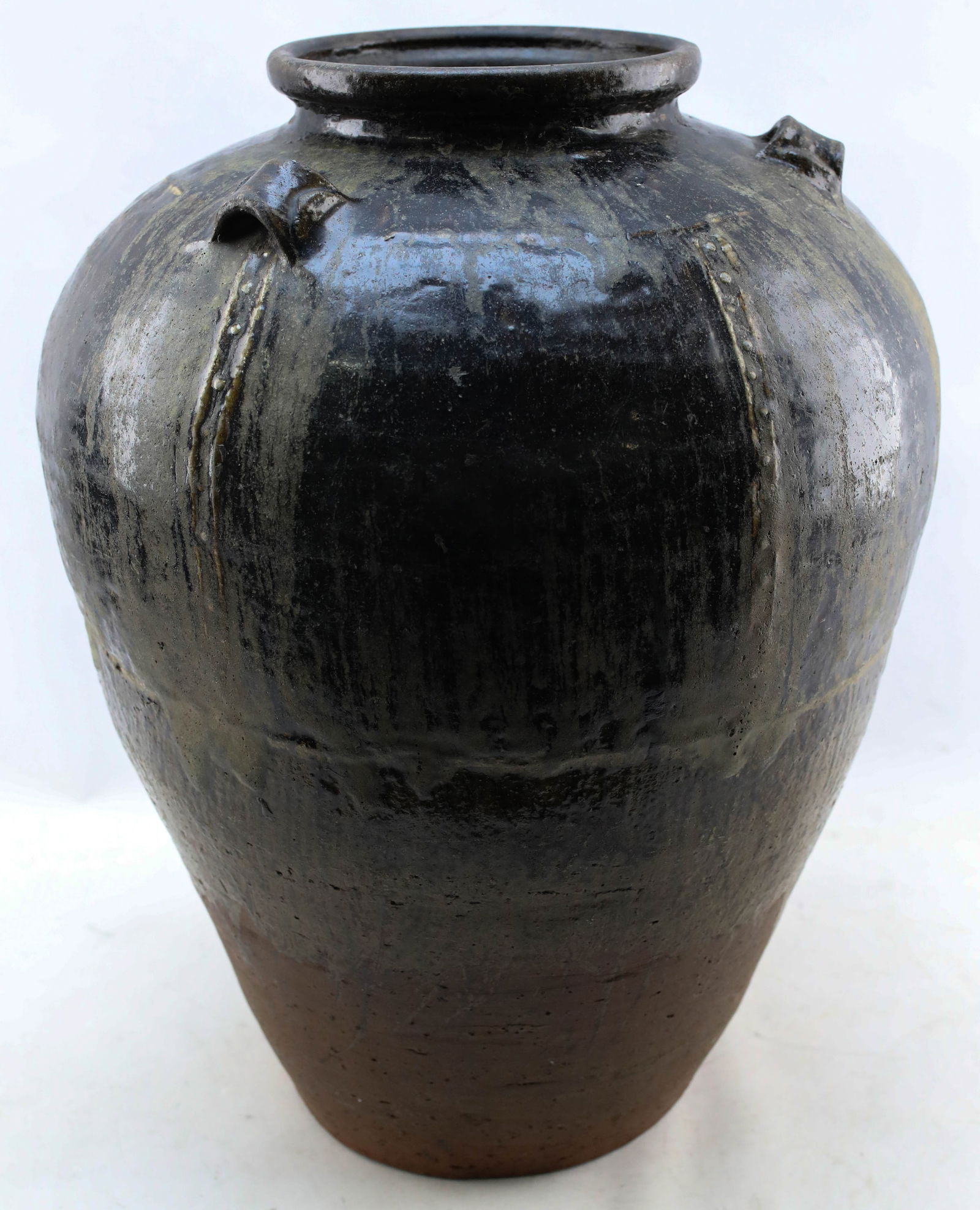 Large Antique Southeast Asian Martaban Spice Jar 2: Large antique clay Martaban glazed ceramic spice jar from Southeast Asia. These vessels are typically from Myanmar (Burma), though similar vessels exist in other countries in the region. Antique, like