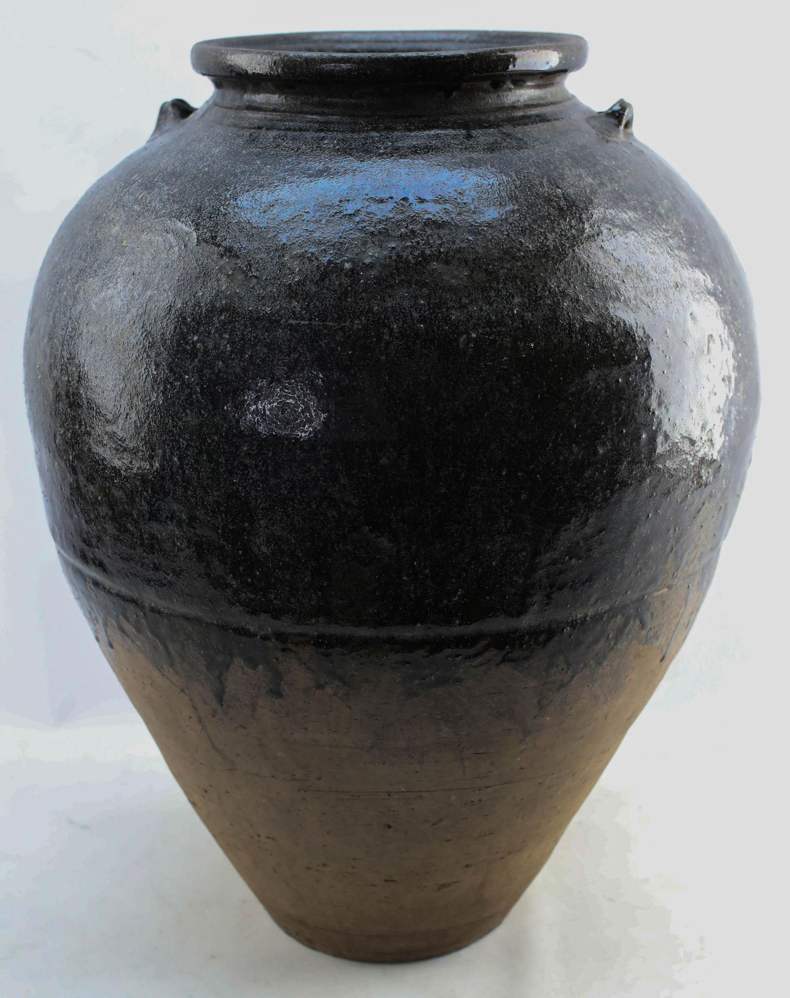 Large Antique Southeast Asian Martaban Spice Jar 1: Large antique clay Martaban glazed ceramic spice jar from Southeast Asia. These vessels are typically from Myanmar (Burma), though similar vessels exist in other countries in the region. Antique, like