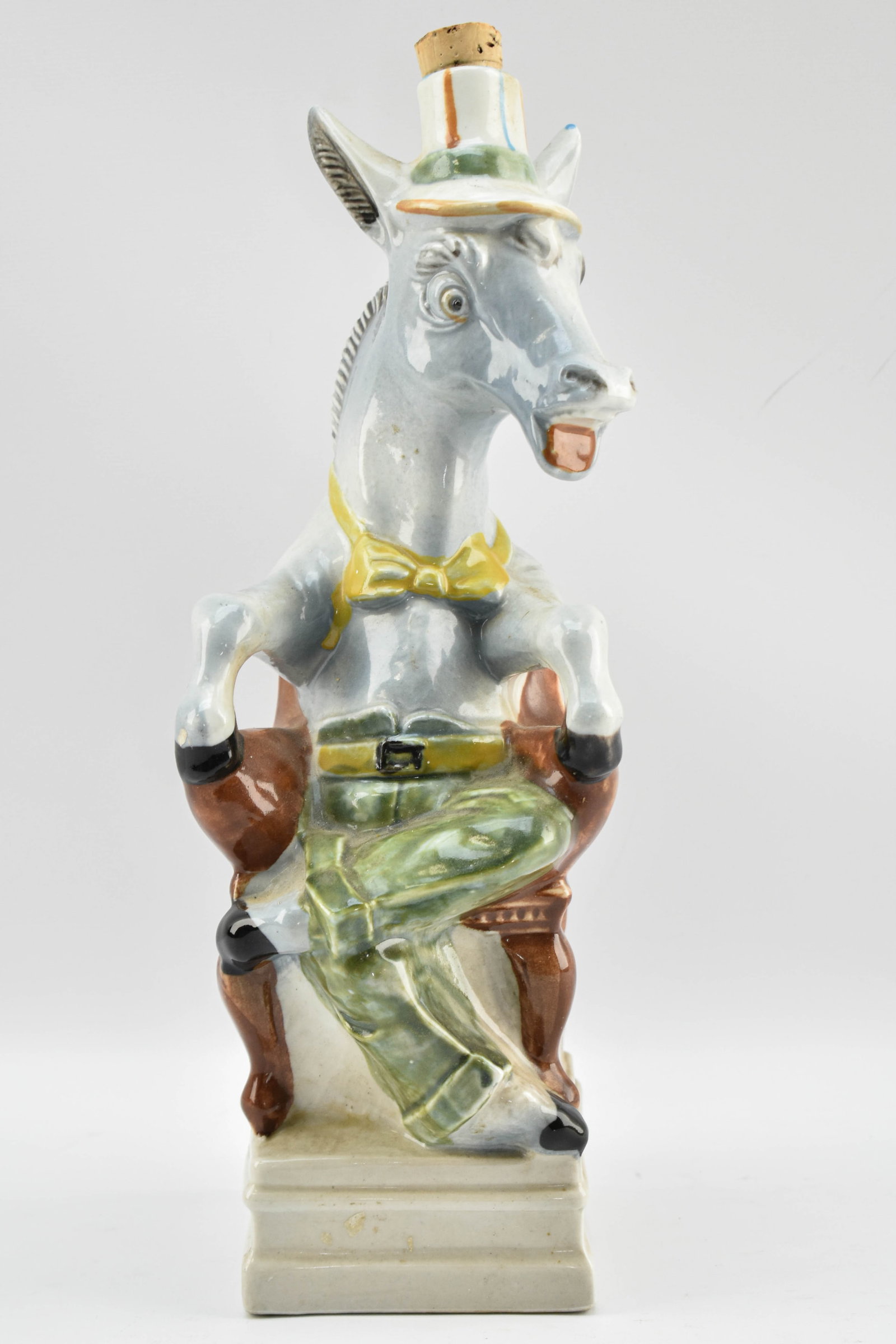 Vintage Donkey-Shaped Chianti Decanter by Bardi Ubaldo: Vintage hand-painted ceramic decanter for red wine shaped like a seated donkey wearing a hat, bowtie, and trousers. The hat uncorks to reveal an aperture for chianti. Produced by Bardi Ubaldo in Italy