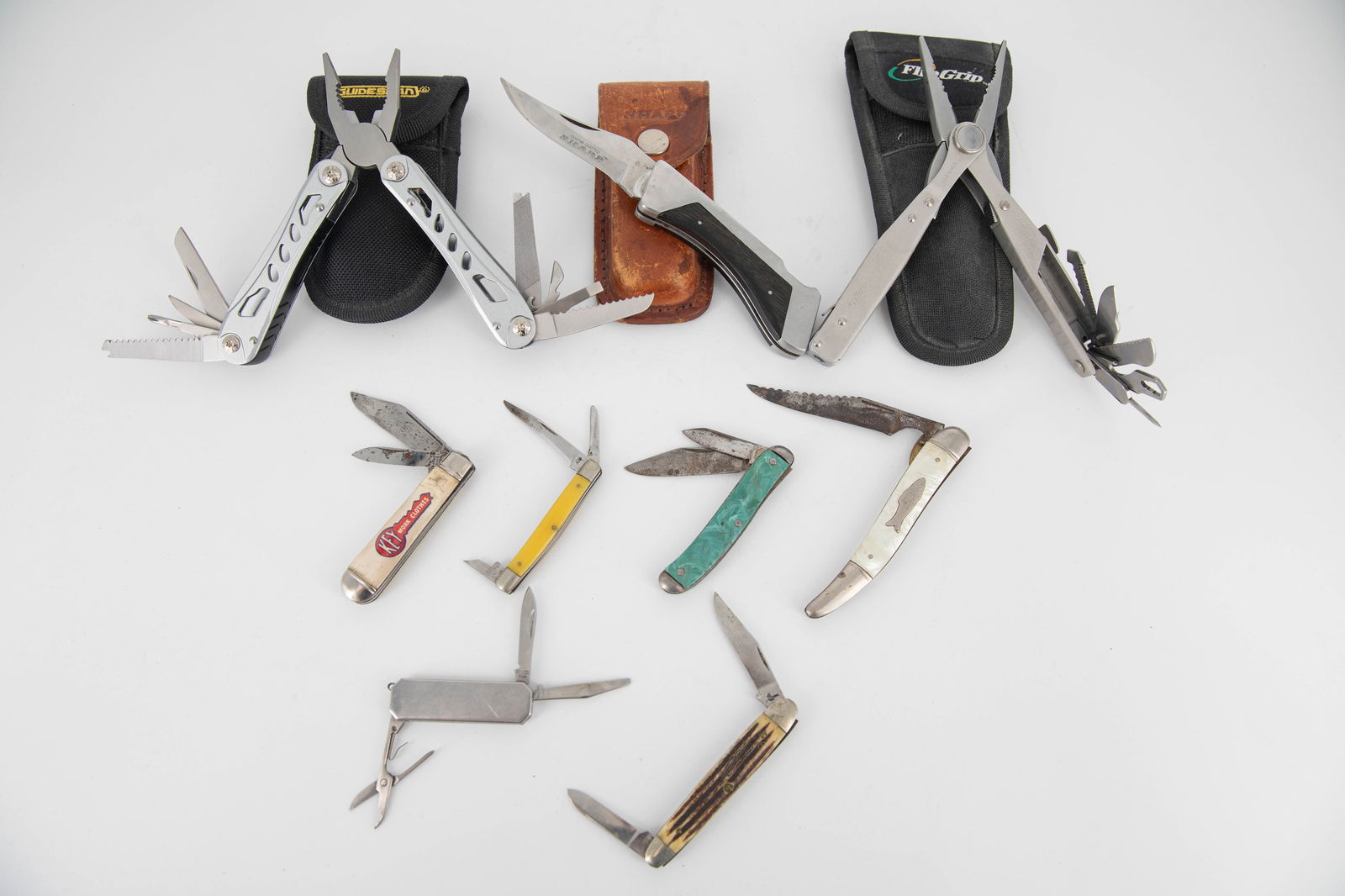 Group of Nine Pocket Knives & Multi Tools: Group of seven pocket/folding knives and two folding plier multi tools. Majority appear vintage. Variety of brands and styles. Three with cases, including a Sharp folding knife with a leather case, a