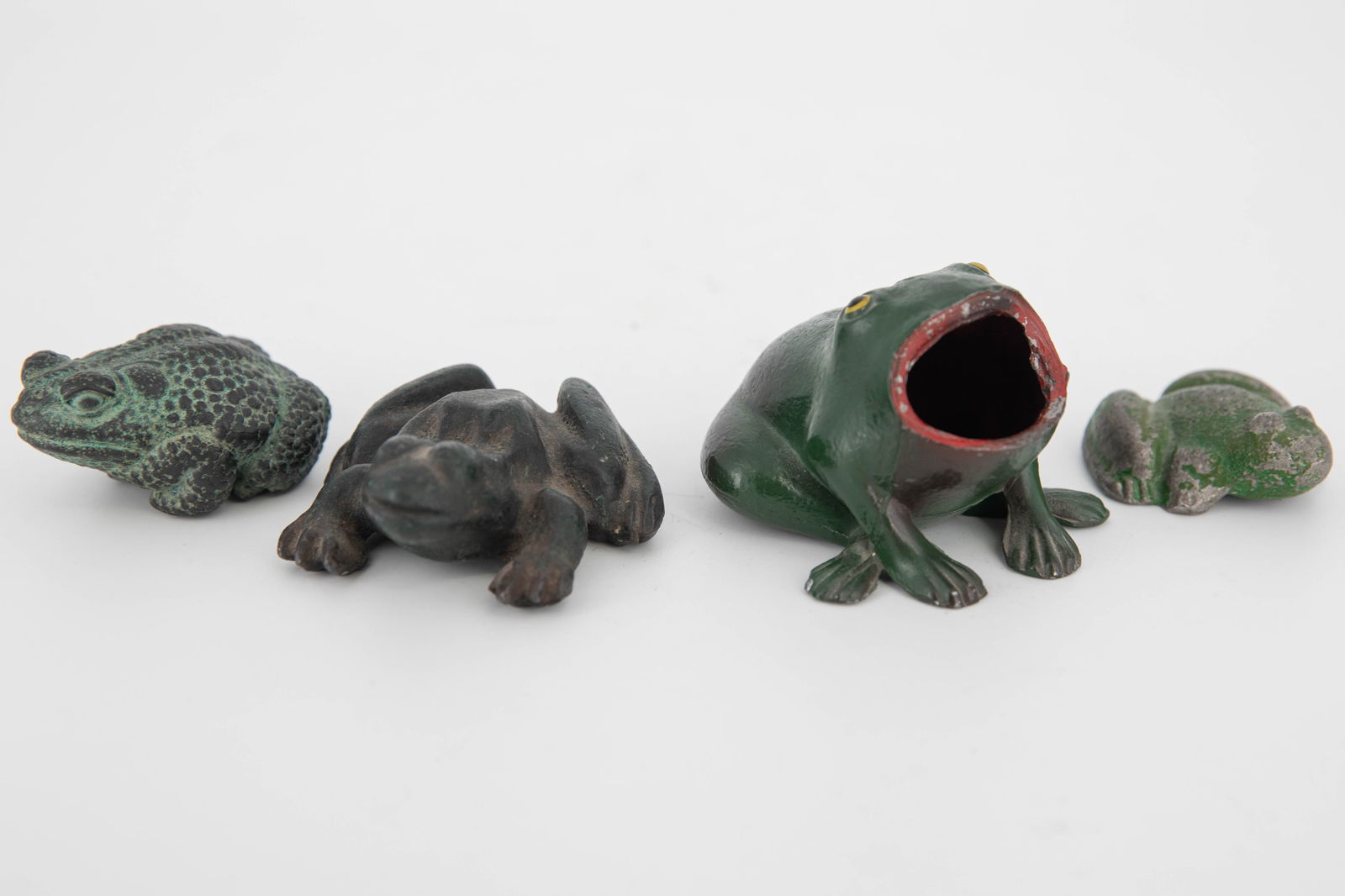 Four Metal Decor Frogs & Toads: Three metal frogs and one metal toad for garden decor, doorstops, paperweights, etc. Two are painted. One has an open mouth and can be used as a small bud vase or perhaps a hide-a-key. Likely vintage,