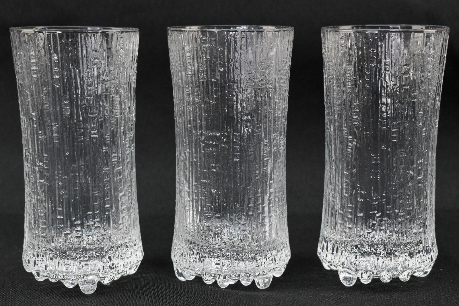 3 Iittala Ultima Thule Champagne Glasses: Three iittala Ultima Thule footed champagne glasses with a textured design inspired by ice.
