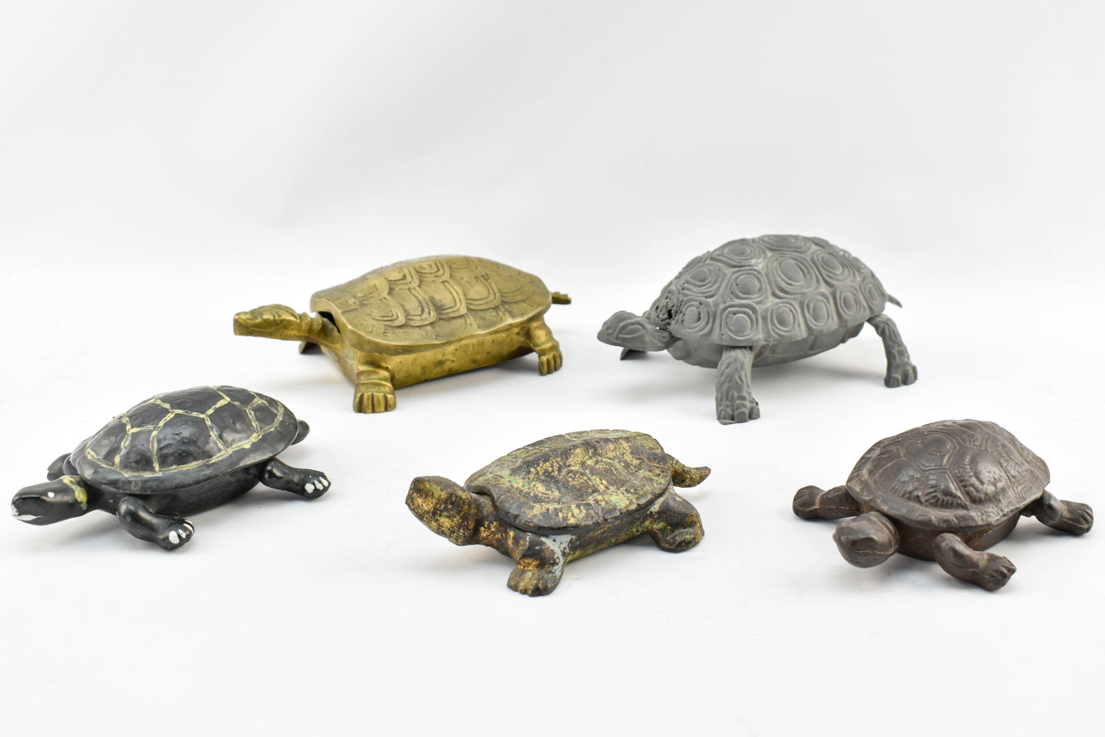 Five Vintage Metal Turtle Chests: Group of five small metal chests in the form of turtles. Some with pigment, gilt, or painted details.