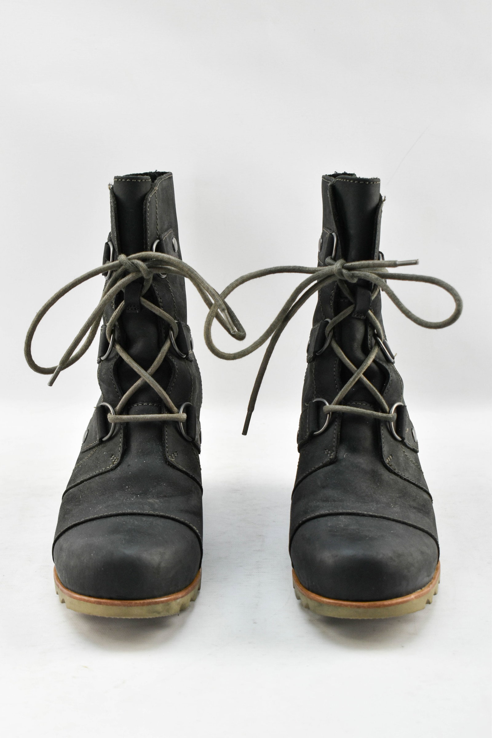 Pair of Sorel Leather Wedge Boots: Pair of black leather rubber wedge boots by Sorel, possibly in their Joan of Arctic style. Features durable laces, stylish topstitching, and metal lace loops. Women's U.S. size 9.