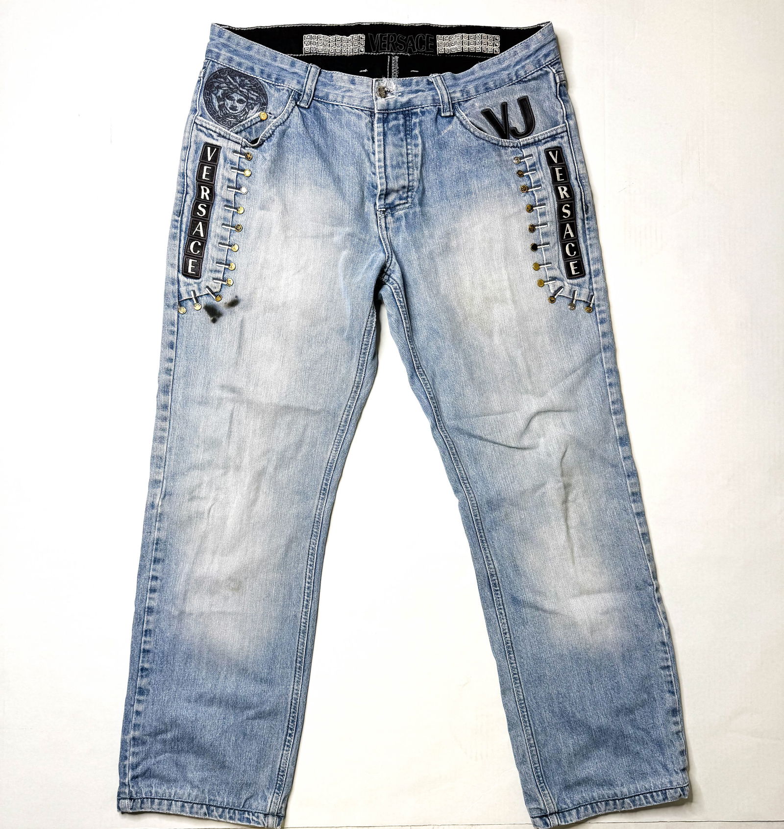 Vintage Versace Embroidered Rivet Jeans, 34/34: Vintage Versace jeans with embroidered Medusa heads and letters spelling out Versace as well as faux button details on the front and back pockets. Leather on the bottom of the rear pockets. Size 34W 3