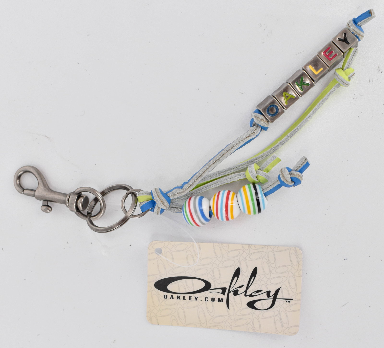 Rare Vintage Oakley Beaded Keychain, Brilliant Blue: Rare Oakley vintage beaded keychain, in original package with tag still attached. Likely 90s/early 2000s. Model 89027-64N. Features striped beads and metal letter beads with OAKLEY impressed and color