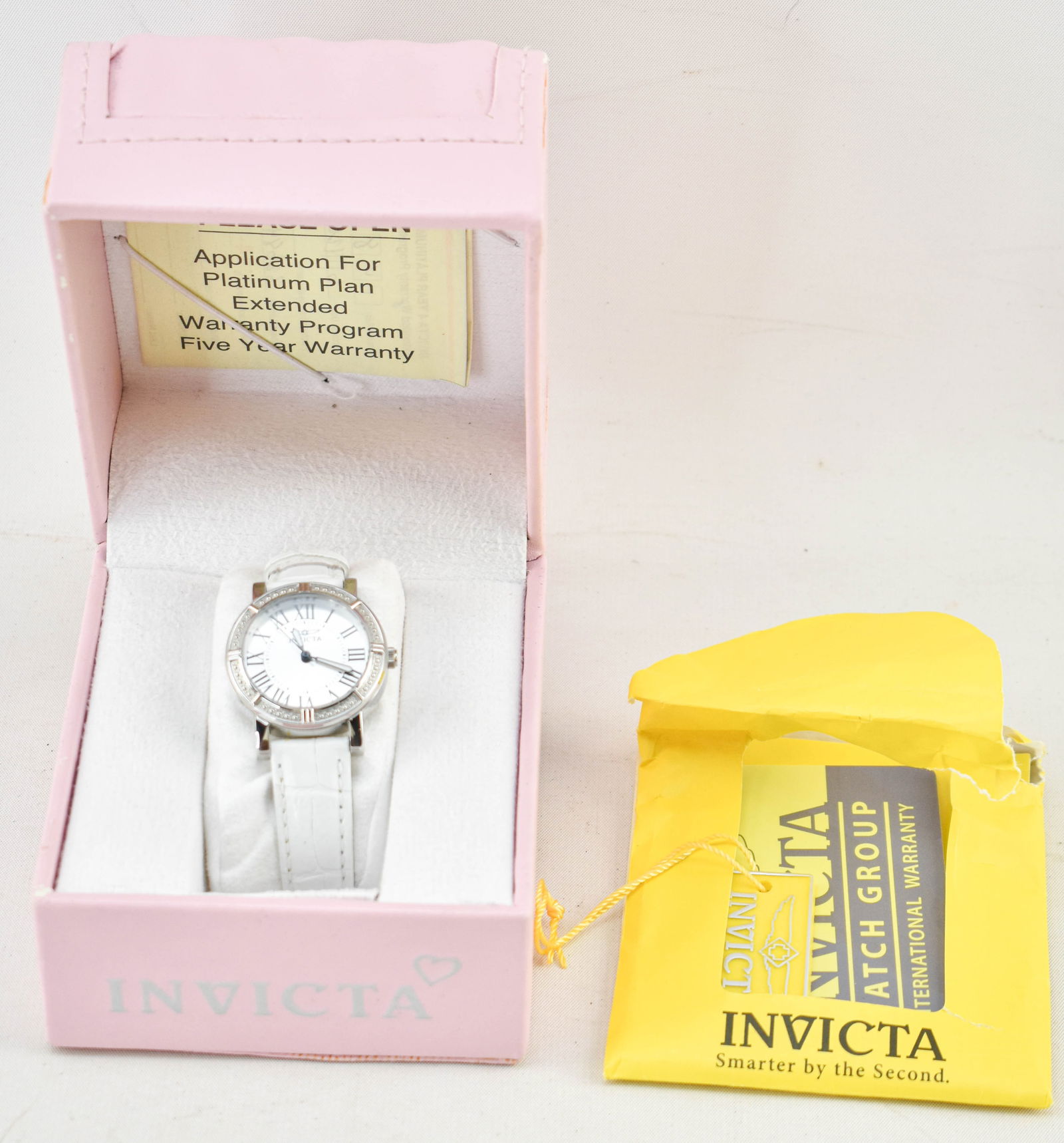 Invicta Wildflower Lady Watch No. 14891 in Case: White leather banded Japan movement watch by Invicta in the style Wildflower Lady model no. 14891, in original pink leather case with tag, warranty card, and instruction manual. Untested, likely in ne