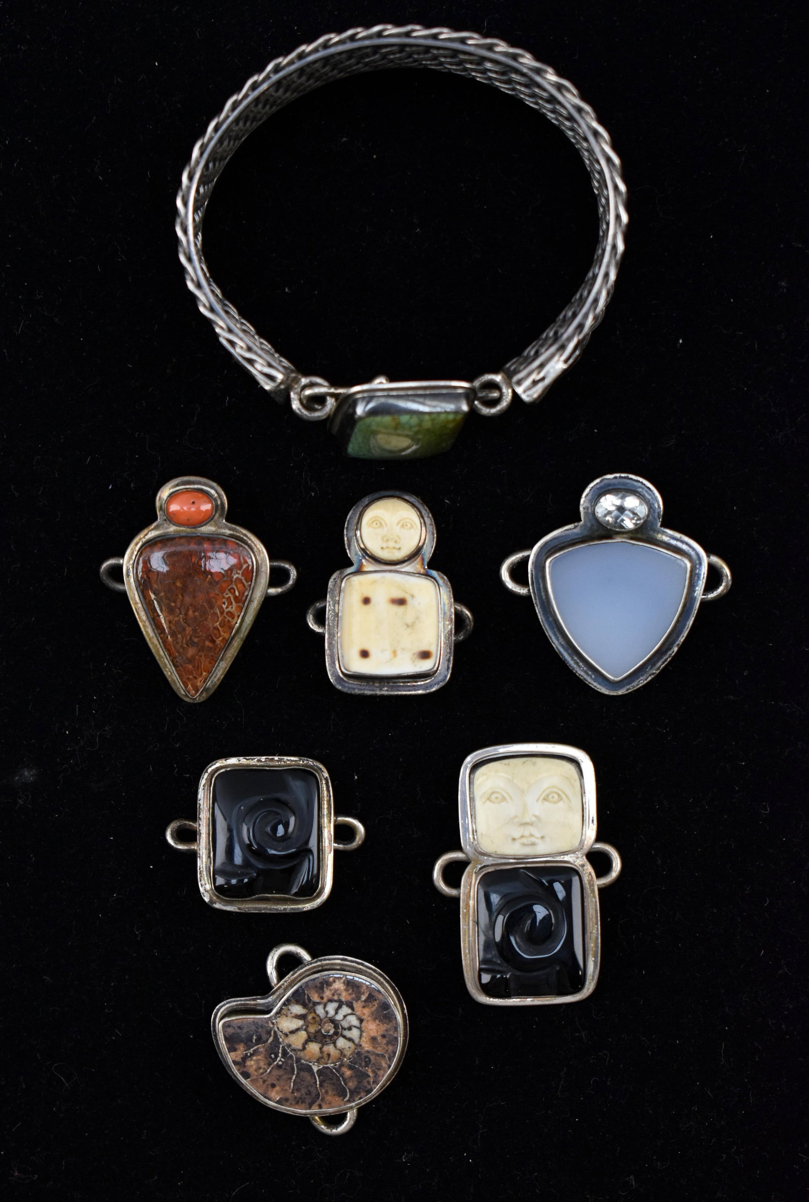 Tabra Sterling Silver Bracelet with Interchangeable Charms: Lot includes one sterling silver bracelet with a woven design and southwest style elements. Also included are 7 interchangeable clasps and/or charms. Charms include elements such as onyx, hardstone, b