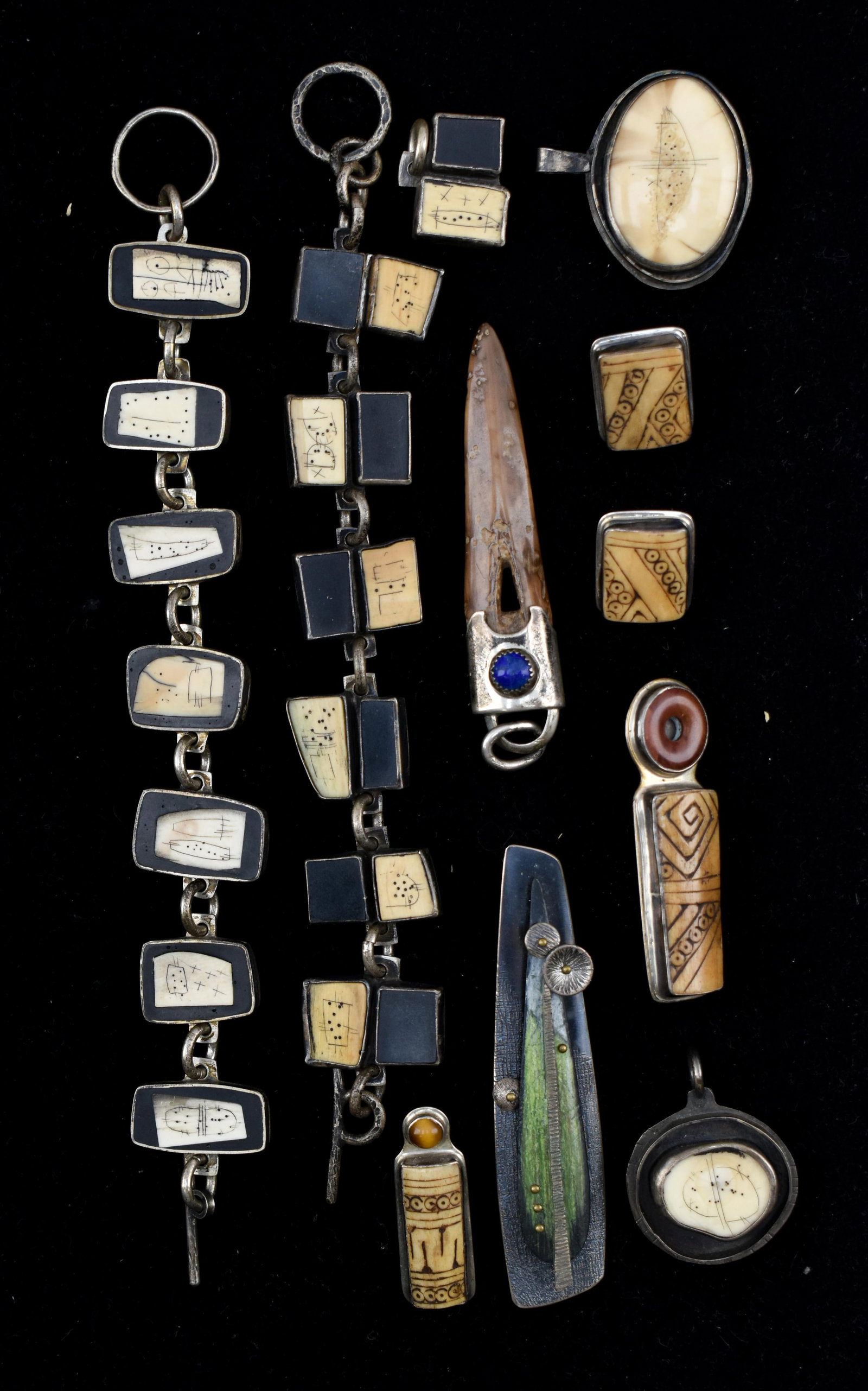 Group of Jewelry with Bone Elements: Group includes 2 bracelets, 4 pendents, 3 pins/brooches, and a pair of earrings. Most pieces feature elements of carved or decorated bone set into silver-toned metal. Some pieces appear to be signed t