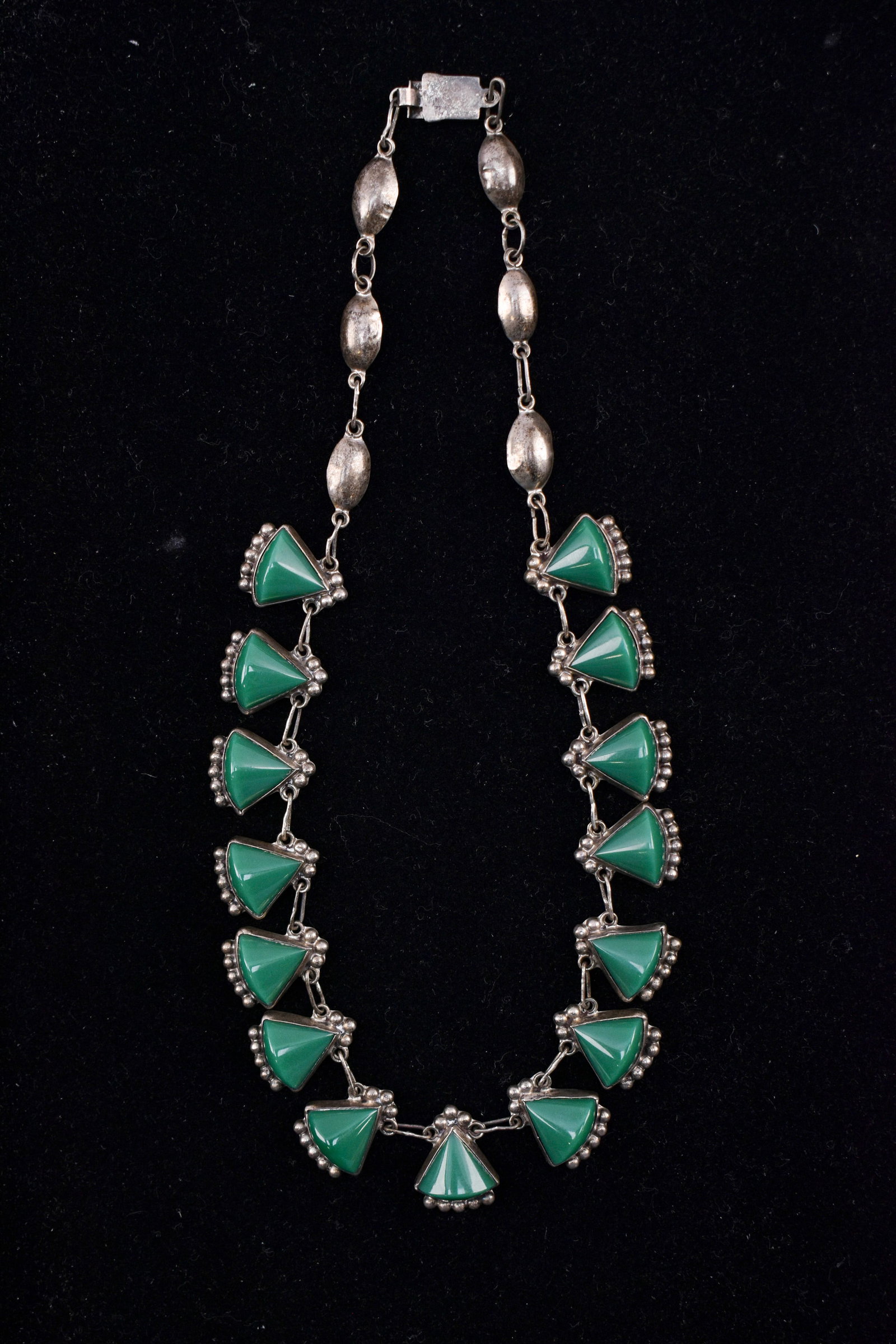 Vintage Taxco Mexican Sterling Silver & Green Onyx Necklace: Vintage Taxco Mexican sterling silver featuring a chain of green onyx in triangular settings. Marked on clasp. 16.25" necklace.
